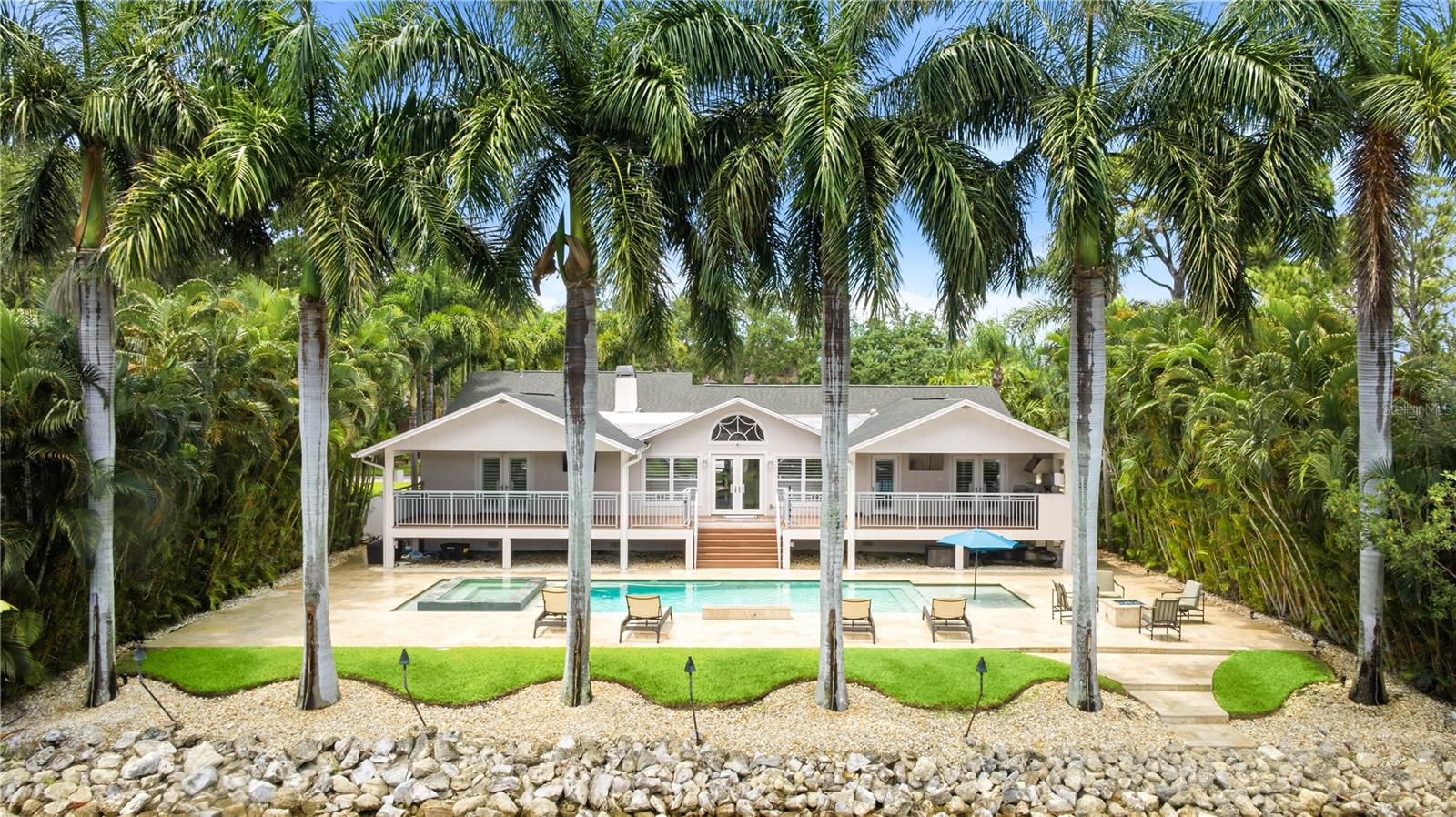 Welcome to this beautifully updated waterfront residence in the sought-after Renaissance neighborhood, within walking distance of Riviera Bay Park in St. Petersburg. Offering 4 bedrooms, 3 bathrooms, including two primary suites, and 2,763 square feet of living space, this home seamlessly blends modern luxury, comfort, and exceptional outdoor living. A new front door welcomes you inside, where newly refinished hardwood floors, a beautifully renovated kitchen and indoor bar featuring a separate beverage refrigerator and wine cooler, and an updated fireplace create a warm and sophisticated atmosphere. Additional features include premium appliances, updated bathrooms, California Closets, plantation shutters, LED cabinet lighting, six mounted televisions, a sound system, variable-speed HVAC, a hurricane-rated garage door, and a pre-wired security camera system. An owner-owned 250-gallon underground propane tank services the whole-house generator, pool heater, two tankless water heaters, outdoor grill, and fire features. Step outside to your private waterfront retreat highlighted by mature royal palm trees lining the canal, a resort-style saltwater pool, a 12-person spa, custom travertine decking, an outdoor kitchen with grill, ice machine, beverage refrigerator, and over 600 square feet of covered entertaining space. This exceptional property is further enhanced with landscape lighting, automated pool equipment, composite decking, and a whole-yard mosquito misting system. Designed for unforgettable gatherings and everyday enjoyment, the backyard offers pool decking extending to the rip-rap seawall, creating the perfect location for a future dock, with water and electric already run to the seawall for added convenience. With every detail already in place, all that's left to do is bring your boat, sit back, and enjoy the waterfront lifestyle.