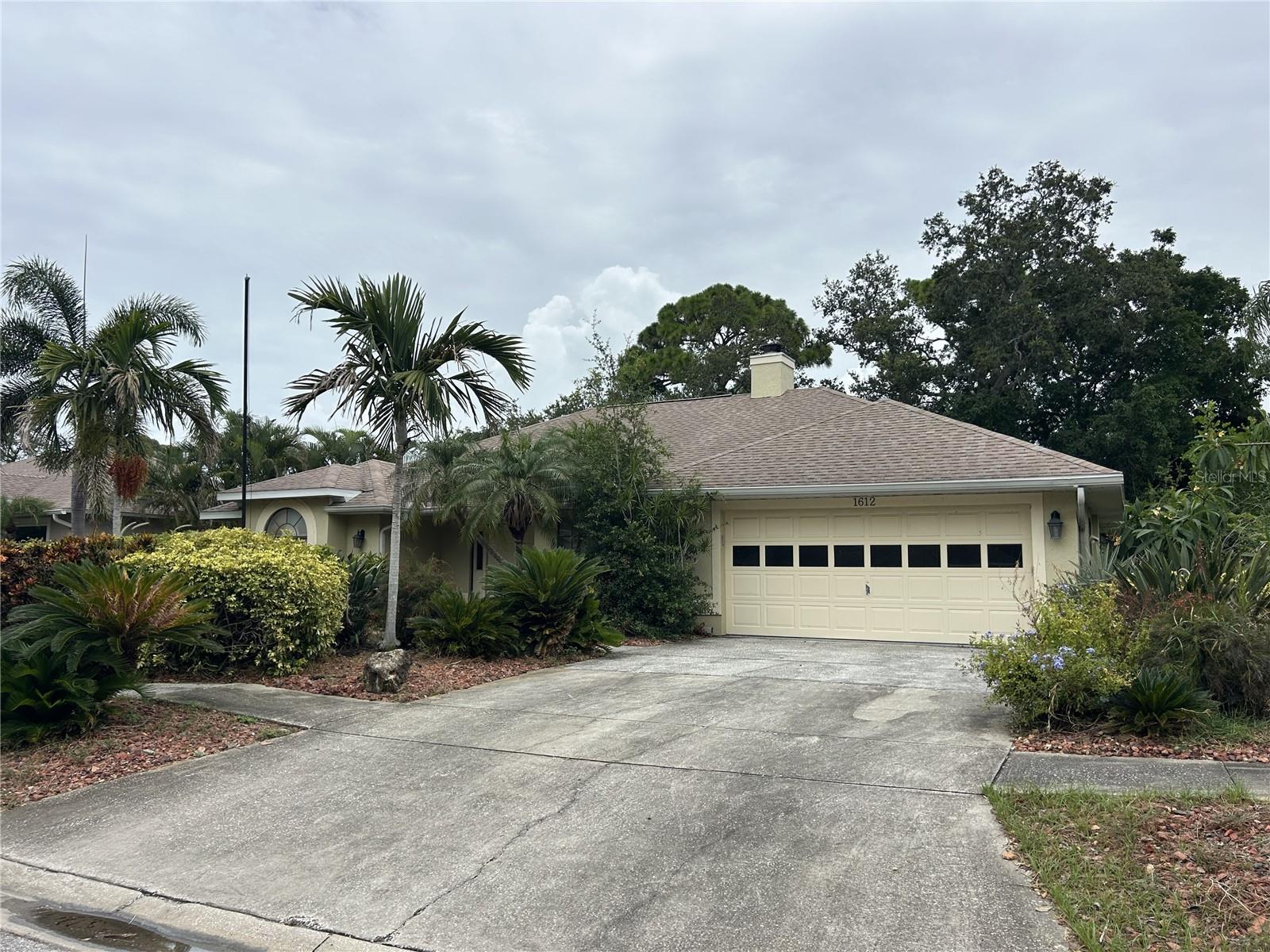 Opportunity awaits with this 3-bedroom, 2-bath home located less than one mile from beautiful Sunset Beach. Offering a desirable split floor plan, this property features a cozy wood-burning fireplace, a spacious 2-car garage, and a covered, screened rear lanai—perfect for enjoying Florida's outdoor lifestyle year-round.  The kitchen is filled with natural light thanks to skylights, creating a bright and inviting space ready for your personal updates and design ideas. With solid bones and an excellent location, this home presents tremendous potential for investors, renovators, or buyers looking to create their dream coastal retreat.  Bring your vision and transform this home into something special while enjoying the convenience of being close to beaches, shopping, dining, and everything the area has to offer.  Don't miss this chance to invest in a property with outstanding potential in a highly desirable coastal location.