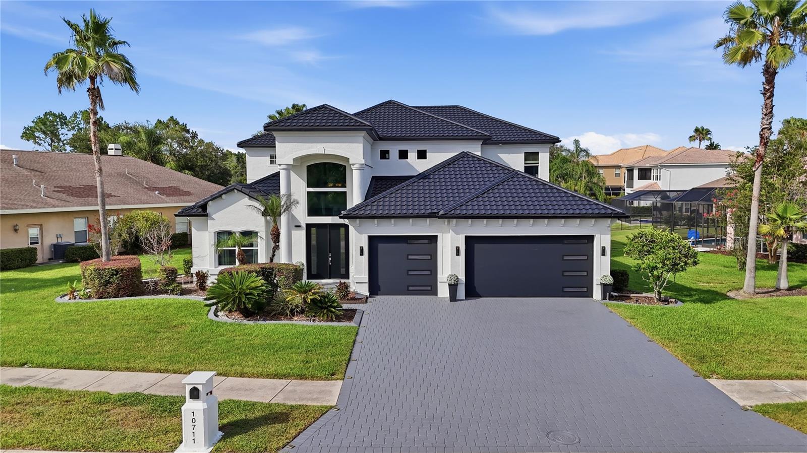 Experience extraordinary lakefront living in one of Tampa's most prestigious gated communities. Perfectly positioned on one of the most desirable homesites in Cory Lake Isles, this exceptional waterfront estate captures sweeping panoramic views across the community's 165-acre ski lake with a picturesque backdrop of mature trees, creating one of the most breathtaking settings in the neighborhood. Offered fully furnished, including a pontoon boat, this truly turnkey residence is ready to be enjoyed from day one. Lovingly maintained and extensively upgraded, this stunning home offers 3,786 square feet of thoughtfully designed living space with 4 bedrooms, 3.5 bathrooms, a private office, an expansive bonus room, and a 3-car garage, all situated on a premium .39-acre homesite. A grand two-story foyer welcomes you into soaring ceilings, expansive living spaces, and spectacular lake views. Imported Tarsus Almond porcelain tile from Turkey flows throughout the main living areas, while rich hardwood flooring extends throughout the rest of the home. Nearly every room showcases breathtaking water views. The spectacular chef's kitchen has been beautifully remodeled with custom cabinetry, dual oversized islands, a dedicated wet bar and coffee station, premium granite countertops with a full-height matching granite backsplash, top-of-the-line KitchenAid appliances, a gas cooktop, built-in wall oven, microwave, and abundant storage. The dramatic two-story family room is anchored by a floor-to-ceiling stone fireplace with a sleek linear electric fireplace, while oversized windows flood the home with natural light and frame the incredible waterfront setting. The spacious first-floor primary suite offers direct access to the lanai and pool, tranquil lake views, dual walk-in closets, and a luxurious spa-inspired bath finished with imported Turkish marble. Upstairs you'll find three generously sized bedrooms, including a private en-suite ideal for guests or multigenerational living, an expansive bonus room with a custom wood accent wall, and an oversized balcony where two bedrooms enjoy spectacular lake views. Outdoor living is equally impressive with a heated saltwater pool featuring a sun shelf with bubblers and umbrella sleeve, elegant imported Turkish marble decking, an expansive covered lanai, and a private dock, creating the ultimate setting for entertaining or enjoying the waterfront lifestyle. Whether it's boating, waterskiing, wakeboarding, paddleboarding, kayaking, or bass fishing, this 165-acre ski lake offers endless recreation right from your backyard. Recent improvements include a brand-new metal roof, hurricane-impact double-pane windows, impact-rated garage doors and front door, new fascia, gutters, fresh exterior paint, beautifully remodeled kitchen and baths, and a newer pool heater. Behind the 24-hour guard-gated entrance, Cory Lake Isles offers a private beach club, lagoon-style pool with waterslide, fitness center, tennis courts, basketball courts, sand volleyball, roller hockey rink, soccer field, playgrounds, parks, community boat ramp, and year-round social events. Timeless craftsmanship, exceptional upgrades, panoramic lake views, and an unparalleled waterfront lifestyle combine to create one of Cory Lake Isles' finest luxury offerings.