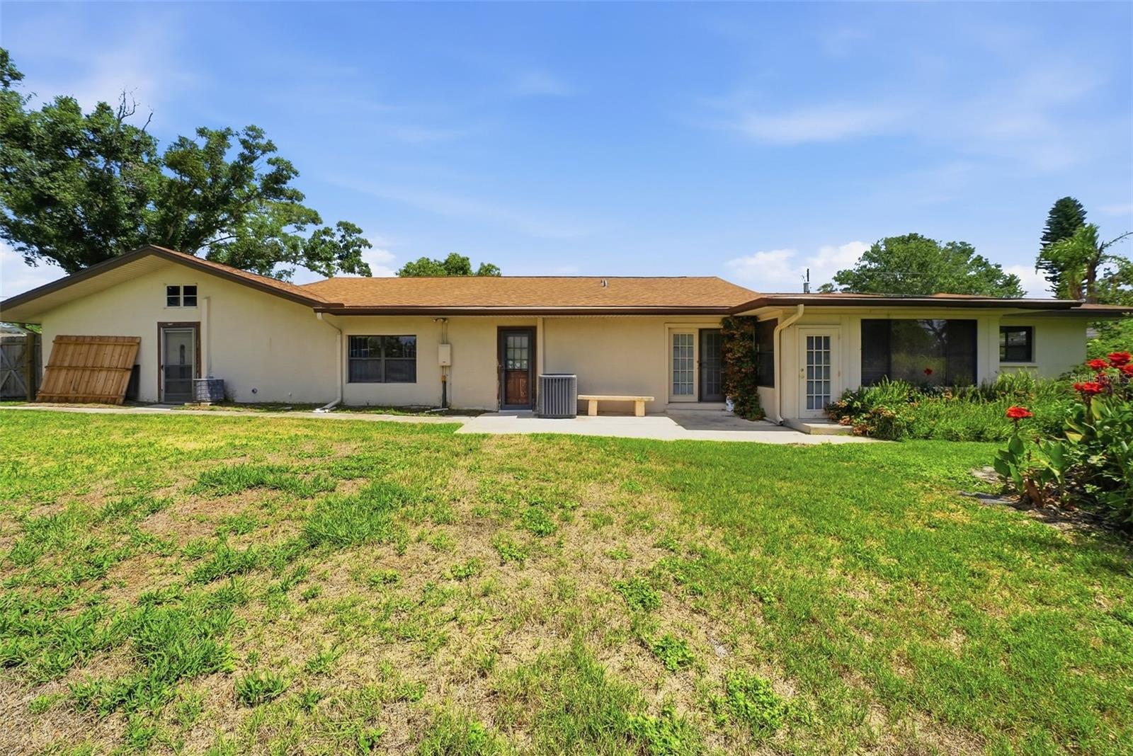 Set on an expansive 0.46-acre lot, this spacious., 5-bedroom, 3-bath single-story home offers exceptional flexibility, comfort, and privacy in one of Clearwater’s most desirable neighborhoods. Built in 1955, this solid block/stucco residence stands out with its rare in-law suite featuring a private exterior entrance, perfect for multigenerational living, guests, or rental income potential.
Inside, the home features multiple living areas, abundant natural light, and a layout that easily adapts to a variety of lifestyles. The dedicated in-law suite provides its own bedroom, living space, and private access, creating a true sense of independence while still being connected to the main home. Whether used for extended family, visiting guests, or a home office, this space adds tremendous value and versatility. The main living areas offer tile, carpet flooring, central heating and cooling, and plenty of room to personalize. Outside, the oversized 0.46-acre lot provides endless possibilities. Just add a pool, expand outdoor living, create a garden retreat, or design the backyard of your dreams. Located on a quiet street surrounded by well-maintained homes, the property benefits from strong neighborhood appeal and long-term value. Just minutes from Clearwater’s world-class beaches, parks, shopping, dining, and major commuter routes, this home delivers the perfect blend of privacy and convenience. Bonus this home is high and dry!!! BEING SOLD AS-IS WITH RIGHT TO INSPECT.