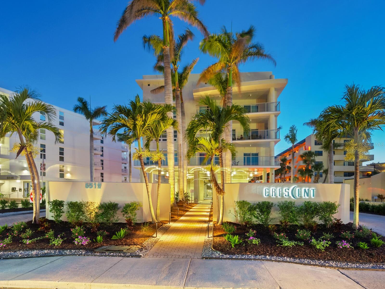 Spectacular, rarely available gulf-front living at Crescent Siesta Key. Savor endless Gulf of Mexico views and world-renowned Siesta Beach’s powdery white sands from this luxurious three-bedroom, three-bath, turnkey-furnished residence in Crescent Siesta Key. Positioned with a desirable southwest exposure, this exceptional condominium blends elegant coastal style with thoughtful design across nearly 2,200 square feet of climate-controlled living space. Towering 11.5-foot ceilings and transom windows flood the open floor plan with natural light, while custom finishes and soft contemporary décor create an atmosphere of effortless sophistication. The chef’s kitchen is a culinary dream, featuring Poggenpohl cabinetry, sleek stone countertops, bar-height seating and abundant pantry storage, all opening seamlessly to the spacious great room and dining area. Go through glass sliders to the expansive 10-by-17-foot terrace, where glass railings frame unobstructed views of the Gulf. Equipped with a summer kitchen, this outdoor haven is ideal for alfresco dining and sunset cocktails. The gracious primary suite is a tranquil retreat, offering breathtaking beach views and direct access to the lanai. The luxurious en-suite bath includes dual vanities, a jetted soaking tub and an oversized walk-in shower. Two additional bedrooms—one with a private bath—provide ample space for guests or the flexibility of a home office or den. A generous laundry room features a full-size washer and dryer, utility sink and built-in storage. This gated, boutique enclave of just 26 residences offers the ultimate in maintenance-free beachfront living. Built in 2006 to the highest standards, Crescent Siesta Key boasts premier amenities such as direct beach access, a beachfront pool and spa, a lap pool, a poolside summer kitchen, fitness center, social lounge, clubhouse, elevators and a beautifully landscaped garden terrace. Two covered parking spaces are conveniently next to the secure lobby elevator. The property also includes 24-hour video surveillance, keypad-secured common areas and an EV charging station. Pet-friendly for owners and offering excellent rental income potential with one- and two-week minimum rental periods, this exceptional property is ideal as a full-time residence, vacation getaway or high-performing investment. Just moments to Siesta Village and mainland Sarasota’s cultural, dining and shopping experiences, this is the pinnacle of Gulf-front living on Florida’s celebrated beach.