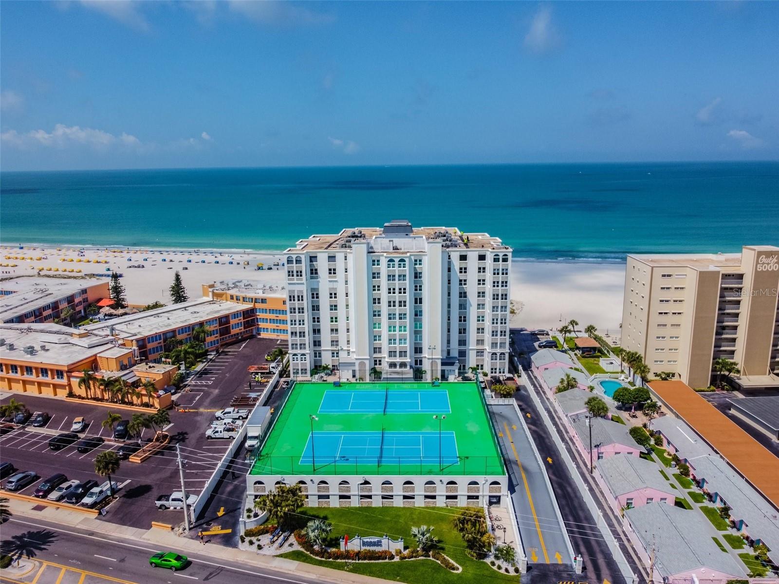 MOVE-IN READY! INCREDIBLE VIEW! Live the coastal lifestyle you’ve been dreaming of in this elegantly upgraded beachfront condominium in prestigious Beau Monde on St. Pete Beach. Unit #206 combines privacy, sophistication and resort-style amenities, making it the ideal full-time residence or seasonal escape. Go through a custom wrought-iron gated entry into an open-concept living space with soaring 10-foot ceilings and expansive hurricane-impact arched windows fitted with custom Hunter Douglas shades. The airy layout seamlessly connects the spacious living and dining areas, creating an environment for entertaining or relaxing beachside. The kitchen features high-end stainless steel appliances, marble countertops, a generous breakfast bar and abundant prep space, ideal for home cooks and entertainers alike. The primary suite offers panoramic views of St. Pete's iconic sugar sand beaches, a large walk-in closet, and an en-suite bath complete with granite counters and a beautifully tiled walk-in shower. Thanks to the unit’s west-facing orientation, enjoy breathtaking sunsets from almost every room. Key features include direct beach access, private (covered) top-floor parking spot, dedicated storage closet, hurricane shutters and custom Hunter-Douglas window treatments, and a successfully passed milestone inspection including a recent $2 million building-wide update (2017). Residents of Beau Monde enjoy exclusive access to an array of upscale amenities including a heated beachfront saltwater swimming pool, fully equipped (will be new as of 2026) fitness center and sauna, tennis and pickleball courts, clubroom, shuffleboard, on-site manager, multiple indoor and outdoor sitting areas, a call-box for added security and a unique open-air atrium. Conveniently just minutes from Gulf Boulevard’s top-rated restaurants, beach bars and boutique shopping. St. Pete Beach offers a vibrant lifestyle with year-round sunshine and entertainment opportunities. The building's rental policy allows 90-day minimums with an on-site property manager, ideal for homeowners looking for flexible use or long-term investment potential. Whether you’re seeking an iconic beachfront home or a high-end vacation condominium, unit #206 is a rare opportunity to own a slice of Florida’s Gulf Coast paradise.