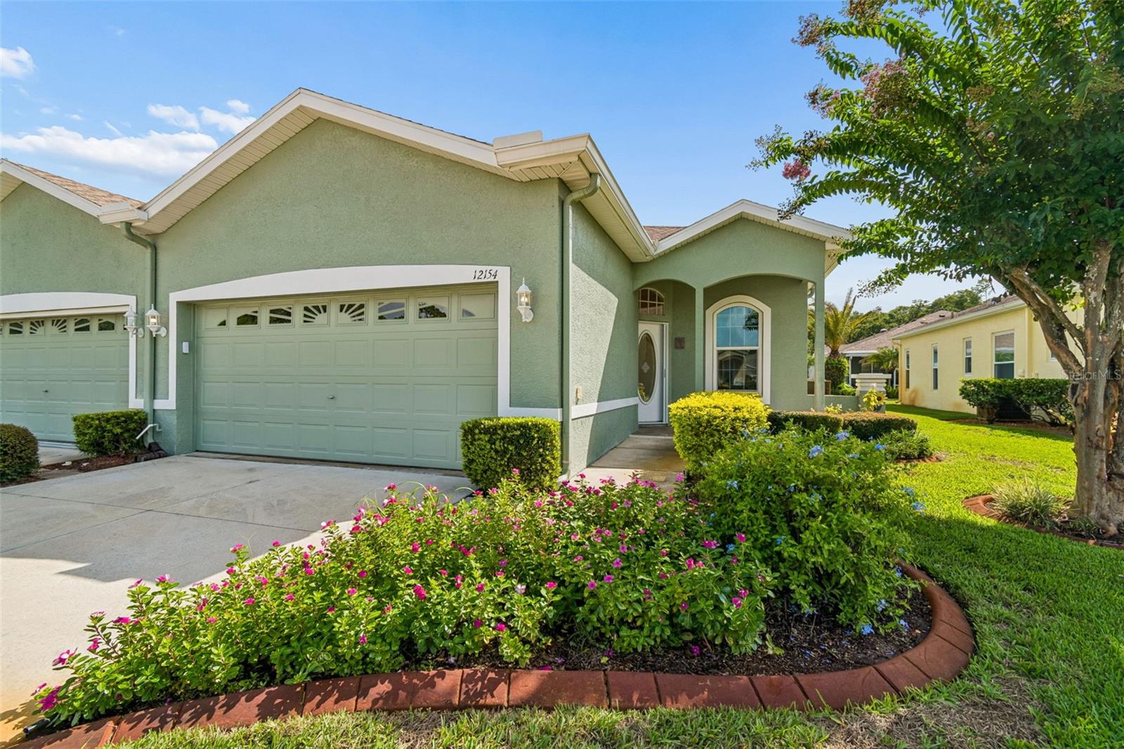 WOW! This FULLY FURNISHED, move-ready villa in popular 55+ Summertree is ready now. Immaculate from the outside in, this 3 bedroom, 2 full bathroom, 2 car garage villa is a show stopper. Located behind the gates, on a cul-de-sac, this home is welcoming and has been tastefully designed/decorated. NO CARPET. Inside, you have beautiful laminated flooring throughout. Laundry room with cabinets is located off of the garage along side a HUGE walk-in pantry. Designated dining room for gatherings opens up into the upgraded and spacious kitchen. Newer stainless steel appliances. Lots of cabinets and storage space provided and counter top space! Light and bright living area with sliding doors to the views of the backyard landscaping. Screened in lanai. Split bedrooms. Primary is located towards the back of the home, is LARGE, and has an ensuite with large closet space and walk-in shower. The other 2 spacious rooms are up front and share a clean FULL bathroom with shower/tub combo. Stunning picturesque windows in every room. All furniture has been well maintained and is modern. Summertree is a maintenance community with lawn care included. Low HOA for what is included: clubhouse, 9 hole golf course, pickleball, heated pool, library, event space with lots of scheduled activities, a work are with computers, bocce ball and SO MUCH MORE! No flood zone and No CDD fees. Home can be rented for $2600/mo with furnishings.