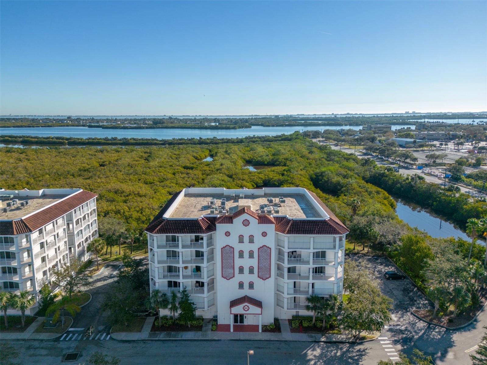 Wake up to panoramic preserve and wildlife views with a front-row seat to rocket launches from your private wraparound balcony! This bright 5th-floor penthouse unit offers an open layout with 3 beds, 2 baths, and abundant light from floor-to-ceiling sliders and plentiful windows. The newly renovated kitchen boasts stunning quartz countertops, bright white wood cabinetry, and stainless steel appliances. The primary features a spa-like en suite bath with soaking tub, walk-in shower, dual vanity, and two walk-in closets. Each bedroom features its own private balcony access. Upgrades include new 2026 HVAC, marble-look tile, and hardwood flooring. An in-unit laundry/utility room adds convenience, and the storm shutters and secure under-building parking offer year-round peace of mind. Residents enjoy a pool, spa, fitness center, gazebo, and clubhouse in a pet-friendly community. In the heart of Merritt Island, minutes from the new hospital, shopping, dining & the beach.