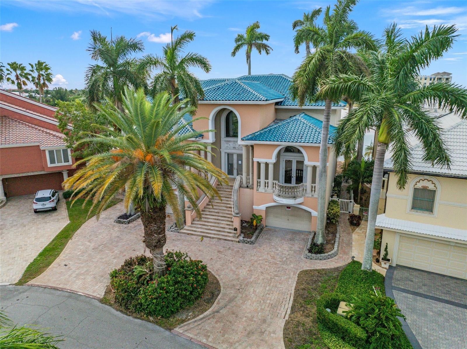 One or more photo(s) has been virtually staged. Auction Property. Tierra Verde at Pine Key - Majestic views of Pass-A-Grill, Shell Key and the Gulf of Mexico.  This is the opportunity of a life time to rehabilitate or build new on arguable the most beautiful lot in Tierra Verde.  The existing estate was initially built in 1991 with glamour and panache.  Grand entry hall, sweeping staircase and marble flooring.  5 bedrooms, most with ensuite bathrooms, theatre room, catwalk, wet bar, nanny quarters, game room, lofts and many other spaces that make up the 3 levels of 8337 heated square feet. Sadly, this beautiful home suffered a fire in it's past and fire damage is most evident in the elevator shaft and lower levels.  This is something that all buyers should be aware of and there is no fire report on record that has been found. The view from this home is simply stunning. The pool and outdoor kitchen space is encircled with multiple balconies and offers private views of Cabbage Key beach across Dents Channel or look the other way over Pass-A-Grill. Expansive views of the Gulf and the horizon beyond. Watch the sailboats ease by at sunset, enjoy the breezes off the water & the smell of salt, watch dolphins and birds in their natural habitat.  Enjoy the nearby Tierra Verde amenities.  The marina, multiple piers, public boat ramps, golf course and of course Fort DeSoto trails.  Restaurants, Tampa International Airport, galleries, museums and the eclectic downtown St. Petersburg are all easy and convenient to travel to.  There will not be another opportunity like this one.  It's good to be home.
