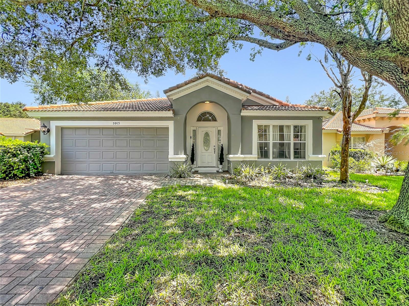 Experience luxury and privacy in this renovated pool home within the gated community of Stonebridge Lakes. This move-in-ready residence is perfectly situated on a dead-end street/cul-de-sac backing right up to a Conservation Area. This home offers a seamless blend of elegance and function, featuring a spacious open and split bedroom floor plan highlighted by pristine marble flooring throughout the main living areas and bathrooms. The living room serves as a true centerpiece, boasting a dramatic floor-to-ceiling stone accent wall with a integrated hidden entertainment center. Designed for seamless indoor-outdoor living, the home features sliding glass doors that fully retract, creating an expansive flow to your private outdoor oasis with a serene pool, hot tub and unobstructed conservation views right from your screened in pool deck. The kitchen is a chef's delight, equipped with a large breakfast bar, granite countertops, tiled backsplash and waterfall center island. Retreat to the primary suite, which includes a spa-inspired bathtub with dual vanities, marble finishes, a deep soaking tub, and a separate walk-in shower. Additional upgrades features include fresh interior paint (2025), hardwood flooring in the bedrooms, a smart thermostat for energy efficiency, and a durable tile roof. Bedroom 2 offers the added convenience of direct access to the second bathroom. The garage currently features a finished, centrally air-conditioned bonus room - perfect for a home office, gym, or media room. The space can be converted back into a full 2-car garage if desired. Don't miss this unique opportunity to own a meticulously maintained home in a prime, peaceful location!