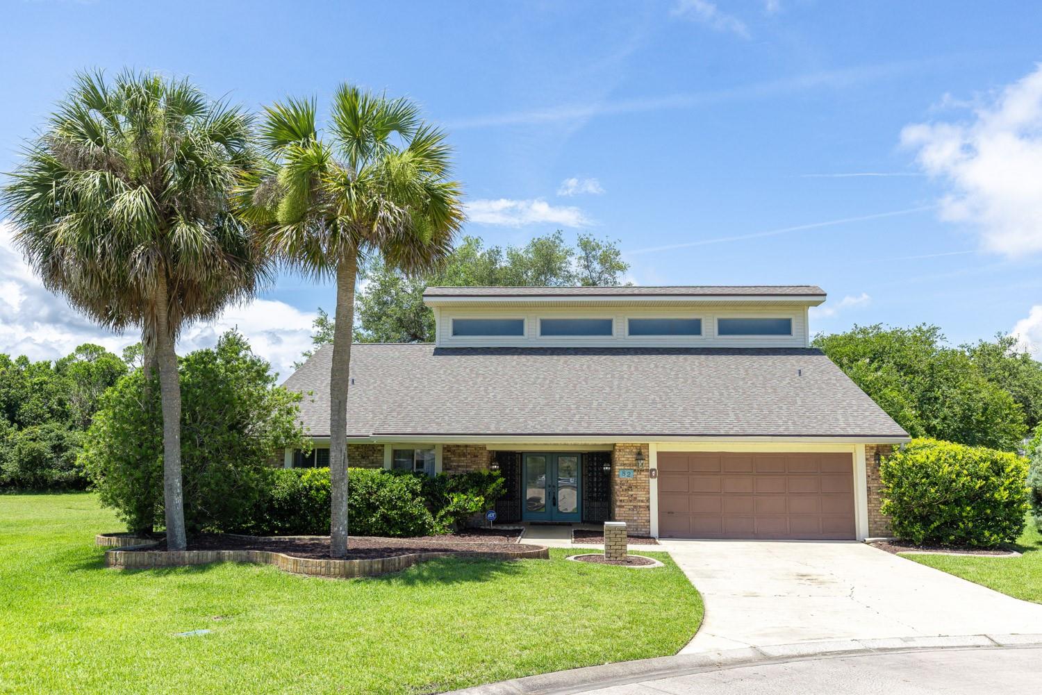 Nestled on an oversized cul-de-sac homesite in the sought-after Plantation Bay community, this 3-bedroom, 2-bath residence offers approximately 2,468 square feet of thoughtfully designed living space with a blend of comfort, character, and lifestyle appeal. The open floor plan is enhanced by white shaker cabinetry, stainless steel appliances, updated bathrooms, and a striking double-sided wood-burning fireplace that creates a warm focal point between the living areas, while a spacious loft overlooking the main living space adds flexibility for a home office, media room, or hobby area. All three bedrooms are conveniently located on the main floor, providing a practical layout for a variety of living arrangements. Just a short golf-cart ride from 45 holes of championship golf and approximately 1,000 feet from the recently unveiled Plantation Bay Club de Bonmont clubhouse, residents may enjoy access to optional amenities including fitness facilities, resort-style pools, tennis, pickleball, clubhouses, and dining venues. With room to add a pool, 24-hour security patrols, multiple gated entrances, and Flagler Beach access only minutes away, this property presents an exceptional opportunity for buyers seeking a private golf-course community lifestyle along Florida's scenic coast