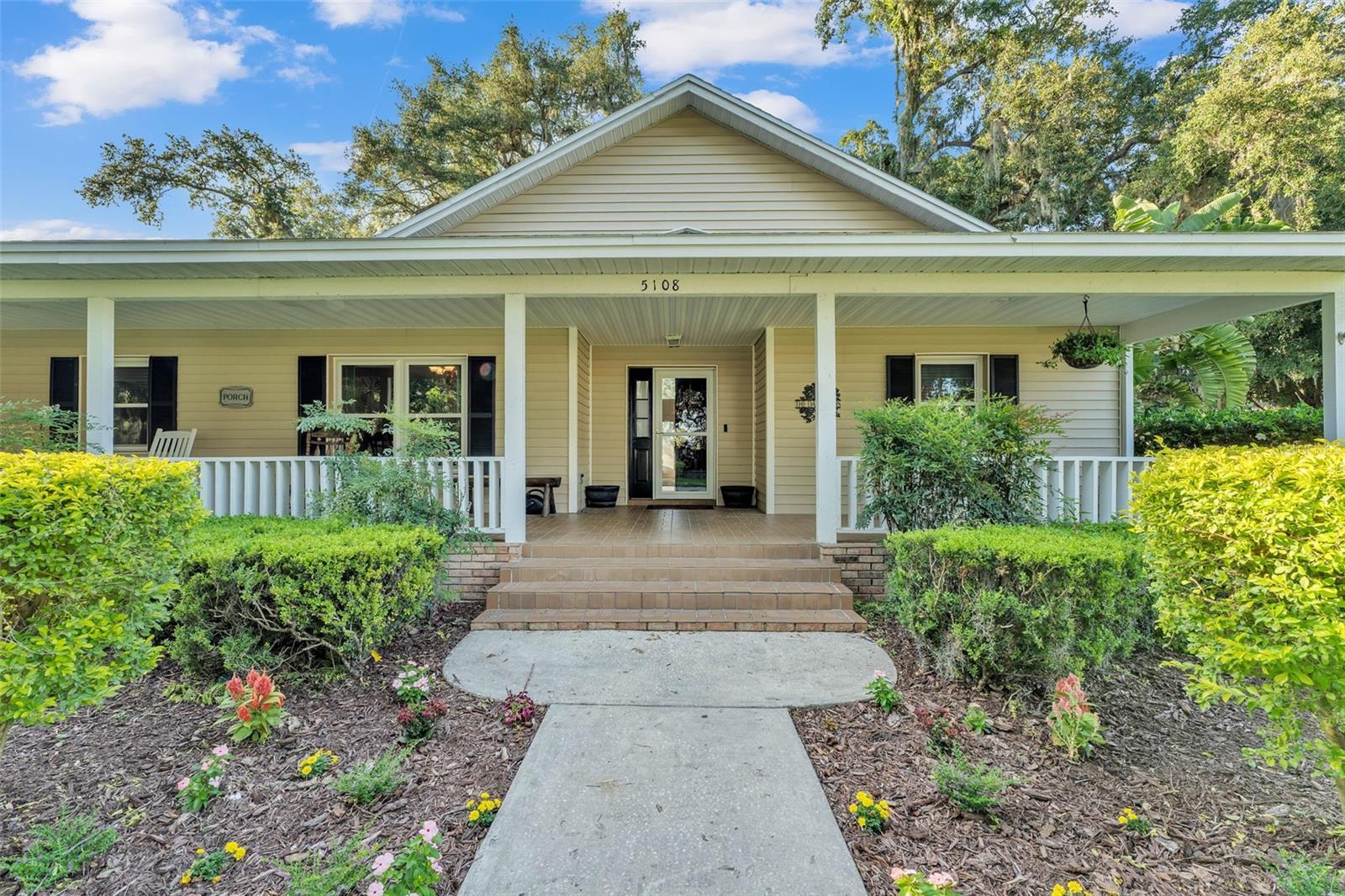 MOTIVATED SELLERS!  This 3-bedroom, 2-bath home situated on a spacious 0.72-acre lot with no HOA in the desirable Waterwood subdivision. A long, welcoming front porch invites you inside to a bright split floor plan featuring vaulted ceilings, an open living area with a fireplace, and a separate dining room. The kitchen provides ample cabinet storage along with a cozy breakfast nook.  Outdoor living shines with a large back patio, vinyl-fenced backyard, and a screened porch off the primary bedroom—perfect for morning coffee or unwinding in the evening. The home is connected to a separate well for irrigation, keeping lawn care easy and utility costs low. Bonus space alert! The property features a 2-car garage, with one side currently enclosed and under A/C, being used as a flexible 4th bedroom. This area is not counted in the heated square footage but offers great versatility and can be converted back to a full 2-car garage if desired.  There's plenty of parking with an oversized circular driveway. Conveniently located near the Polk Parkway, Fort Fraser Trail, schools, shopping, and a nearby public boat ramp.