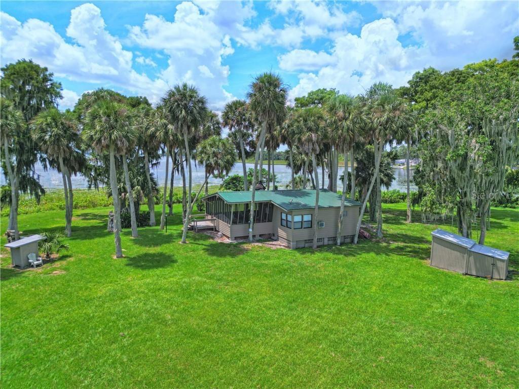 Private Island Paradise on Lake Pierce | Lake Wales, FL Camp House | Fruit Trees | Power & Well | Cypress Grove | Bass & Crappie/Speck Fishing | Near Cherry Pocket Discover your very own private island oasis on Lake Pierce — a hidden gem nestled in the heart of Lake Wales, Florida across from Jennings Fish Camp. This rare island property offers the perfect blend of Florida wilderness, rustic comfort, and modern amenities, making it ideal as a personal retreat, Airbnb, or investment opportunity. Accessible only by boat, the island features a furnished camp house with a screened-in porch, kitchen, living area, double-bed sleeping space, and full bathroom. One of its most unique and unforgettable touches, A palm tree growing through the roof of the screened in porch — a true conversation piece that perfectly complements the tropical vibe. This screened in space is also ideal for an early morning cup of coffee, family board games, or resting in a comfy chair or rocker just enjoying nature. The island is already set up with electricity and a private well, and is surrounded by breathtaking mature cypress trees, offering natural shade and timeless beauty. Enjoy fresh fruit from your own banana trees and two mature, producing mango trees — a rare and delicious perk. Anglers will be in heaven with world-class speck/crappie and bass fishing right off the island’s shoreline. Spend your days casting lines, kayaking, birdwatching, or relaxing in total seclusion. And when you’re ready for a bite or some local flavor, you’re just a short boat ride away from the iconic Cherry Pocket Steak & Seafood Shack, one of the area’s most beloved fish camps. Highlights: Private island on scenic Lake Pierce Rustic camp house with screened porch, kitchen, full bath, and sleeping area Unique palm tree growing through porch roof Private well and electric service in place Banana trees + 2 producing mango trees Towering, mature cypress trees throughout Legendary crappie/speck and bass fishing Minutes by boat to Cherry Pocket Restaurant & Fish Camp Close to Lake Wales and Bok Tower Gardens Ideal for a weekend getaway, Airbnb, or peaceful retirement escape A rare opportunity to own a one-of-a-kind island retreat with modern comforts and authentic Florida charm. Bring your fishing poles, your boat, and your dreams. Inspections are welcome. Property is selling "As Is".
