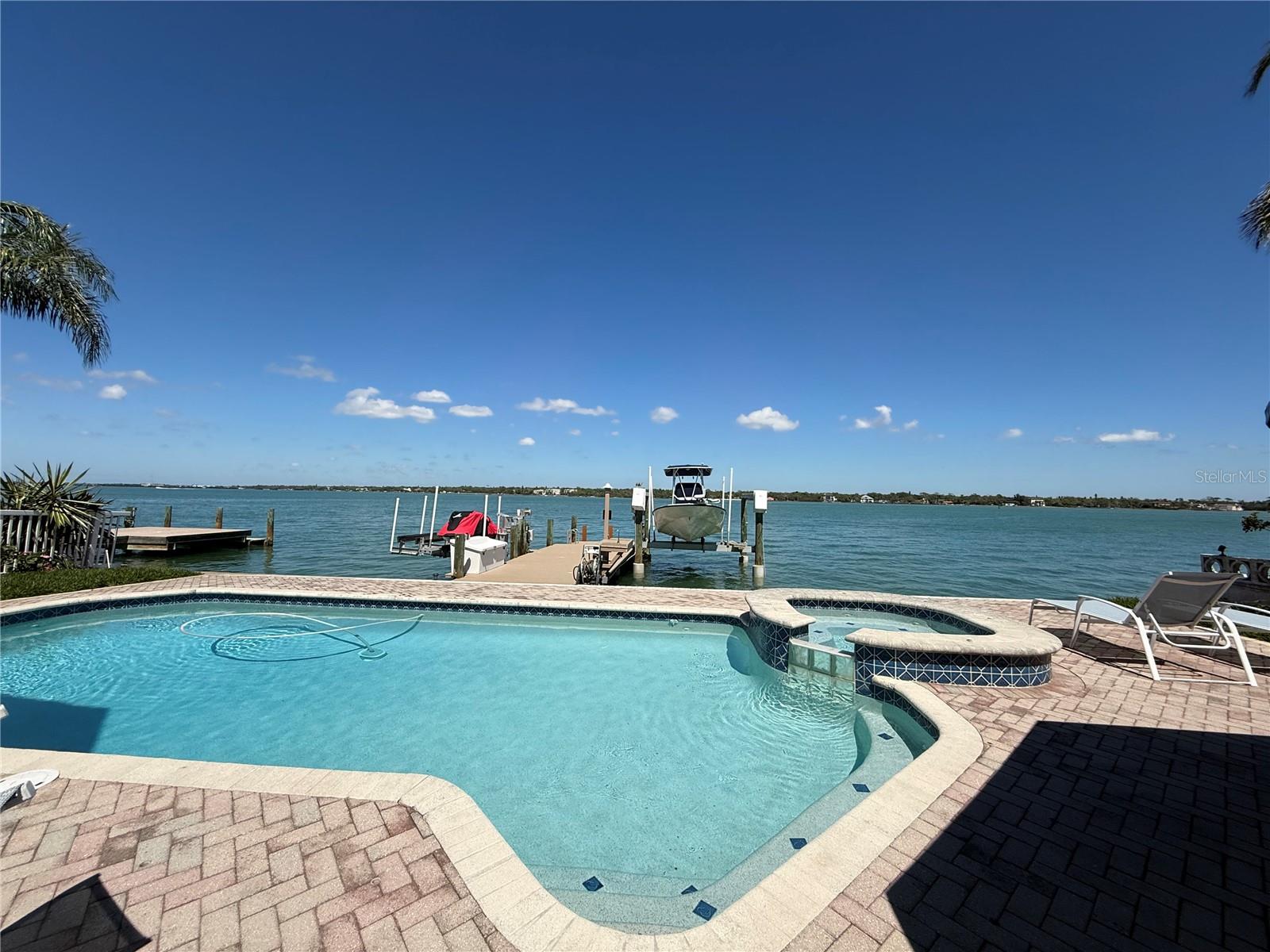 Discover refined island living on Isle of Palms in this renovated two-story waterfront residence offering 4 bedrooms (all located on the second floor), 4.5 baths, and abundant vehicle storage with a 2-car garage plus a 1-car garage. The second-floor bedrooms open to a balcony overlooking the Intracoastal, providing serene morning light. Outdoor amenities are exceptional: a pool, spa, and poolside cabana with an exterior bathroom, plus a private dock equipped with a 13,000-lb boat lift, dual jet-ski lifts, and water and power at the dock. 
This property combines sophisticated coastal design with purposeful functionality—ideal for waterfront living, entertaining friends and family, and effortless access to boating and island recreation. Come make this your forever home.