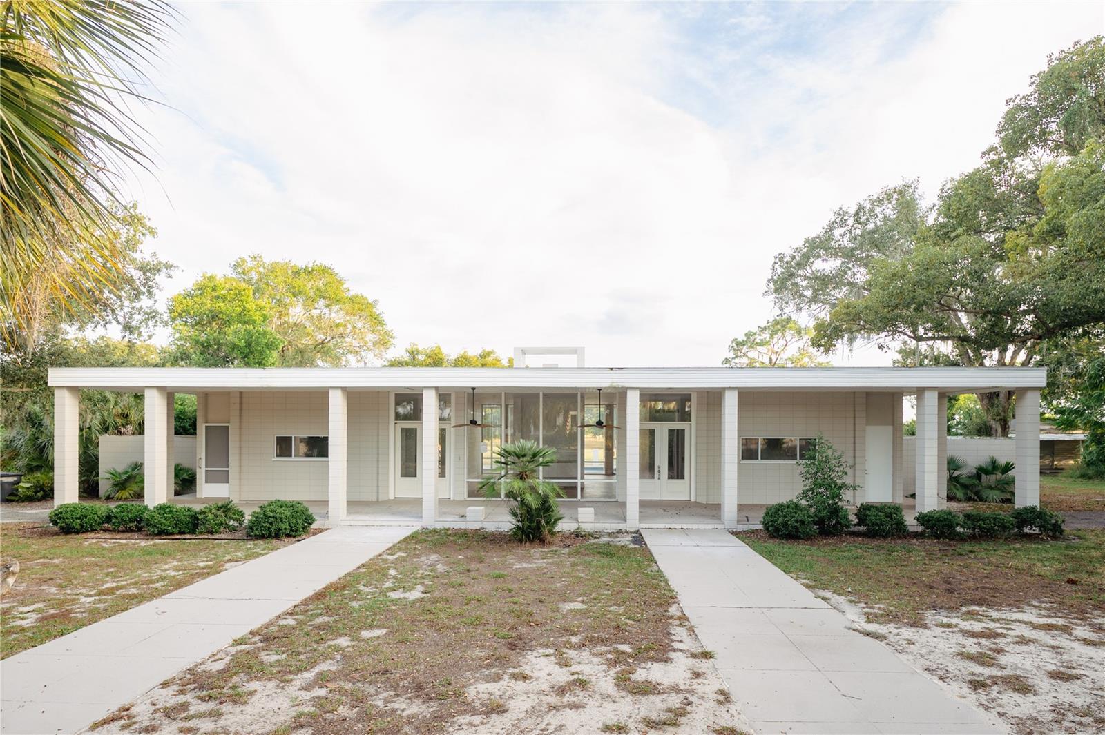 Discover a rare opportunity in the quaint Village of Highland Park, one of Florida’s oldest and most charming, incorporated communities. This extensively renovated estate combines timeless elegance with modern comfort, offering an unparalleled lakefront lifestyle on the pristine shores of Lake Easy.
Set on a rare, expansive parcel just off Lake Easy, this stunning contemporary pool home offers privacy, panoramic water views and soulful Florida sunsets. Nearly completely updated, the residence boasts soaring 10+-foot ceilings throughout, an open, flowing floorplan ideal for entertaining, and generous covered porches that frame the lake views. The home features floor to ceiling windows making light-filled living spaces and a seamless transition to the outdoor oasis. The pool and patio area are positioned to capture dramatic sunsets across Lake Easy. The property sits on over 4.5 acres grounds with deep lake frontage and lush, mature landscaping that provides both privacy and unmatched recreational potential. Rare in this market, this home is a turnkey blend of luxury, comfort, and classic Florida lakeside living.