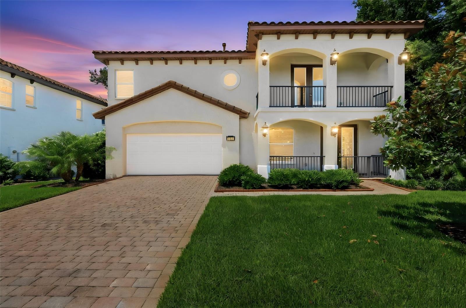 Welcome to this distinctive two-story Mediterranean-style home in the gated community of Lakes of DeLand, where privacy, serenity, and waterfront living come together. Situated on one of the largest lots in the community, the home offers water views in  the back as well as in the front.  The spacious 3-bedroom, 2.5-bath home offers a unique floor plan with thoughtful features throughout. Both levels feature screened porches overlooking the lake, including an upstairs porch with peaceful views of Lake Gem and fountain. A tile roof and mature landscaping add to the home's charming Mediterranean charm.
Inside, engineered hardwood floors installed in 2021 and tile flooring flow throughout the home. Recent updates include interior paint, custom blinds, two new HVAC systems (2026), a tankless water heater, a whole-house water softener system (2024), upgraded Bosch dishwasher, 2026 duct cleaning, and an upgraded burglar alarm system. The welcoming foyer features an elevator, making it convenient for bringing groceries and other items between floors, along with additional storage beneath the staircase. The first floor includes two bedrooms, one of which makes an excellent office, plus a Great room, dining area, kitchenette/bar, and full bath—ideal for guests, extended family, or a private in-law suite. The oversized garage offers epoxy Shark Coating flooring and ample storage.
Upstairs, the spacious primary suite features sliding doors leading to the screened porch with serene water views of Horseshoe Lake. The en-suite bathroom offers double vanities, a Jetta tub, and a walk-in shower. The main living area includes a comfortable living room with a gas fireplace, a dining area, and a well-appointed kitchen with stainless steel appliances, a gas range, prep island, abundant cabinetry, decorative glass-front cabinets with lighting, and a walk-in pantry. A laundry room and convenient half bath complete the upper level.
Outside, the home has been painted, the roof has been professionally cleaned, and a privacy screen has been added to the balcony for additional comfort. Residents enjoy the peaceful lifestyle offered by this private gated community with a park, community dock, and excellent fishing. We cannot emphasize the quality of this home enough, it is extremely meticulously maintained and offers a perfect combination of comfort, tranquility, and convenience, just minutes from shopping, restaurants, and everyday amenities.