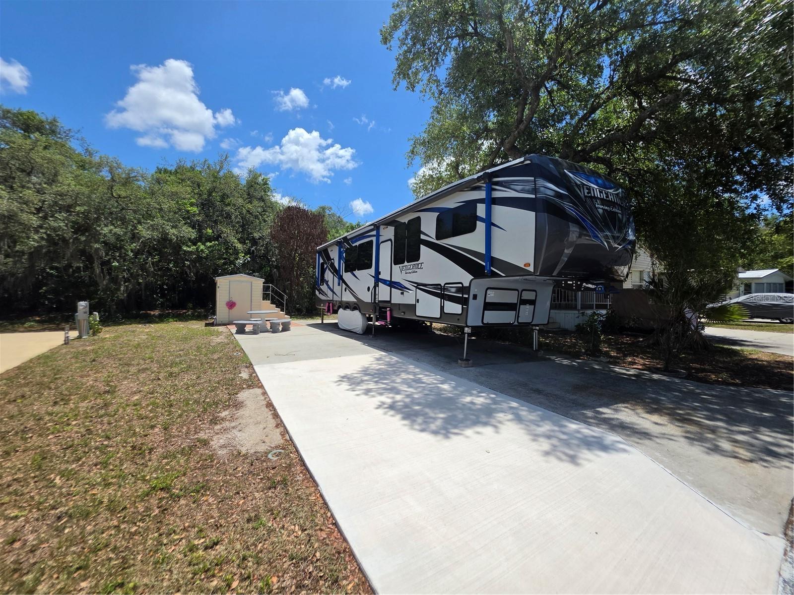 Tucked just off Saddlebag Lake in the peaceful 55+ South Shore Resort community, this well-maintained RV lot is ready for immediate enjoyment, whether you're planning a seasonal escape or a smart addition to your portfolio. The lot features a paved RV pad and private storage shed, with easy access to resort-style amenities including a lakefront pool, fishing dock, clubhouse, and shuffleboard courts. Pride of ownership shows throughout the beautifully kept grounds.

Conveniently close to shopping, dining, SR-60, and Florida's Turnpike. Stay connected without sacrificing the quiet charm of lakeside living. Slow down, settle in, and start your next chapter here. (Camper in the photo is not included)