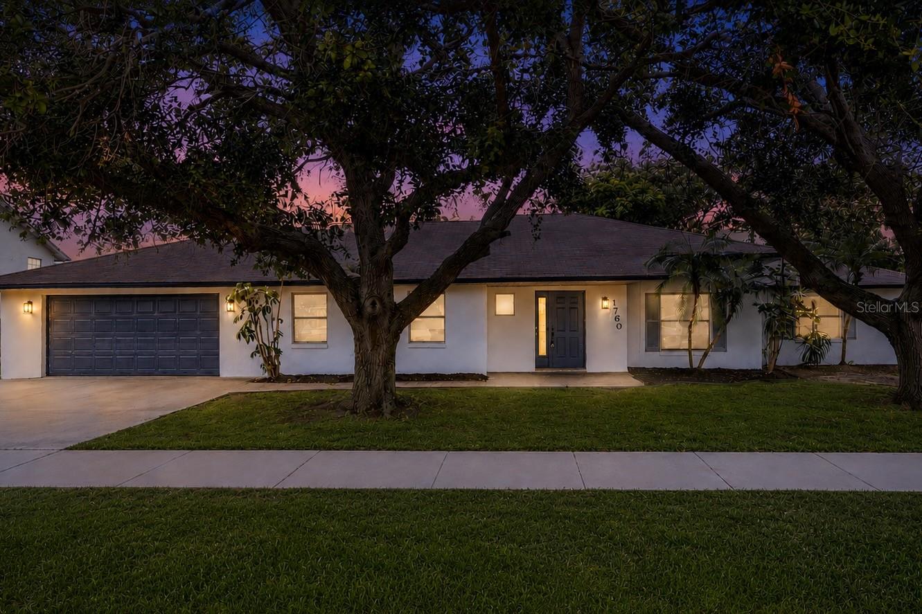 Welcome to this beautifully renovated 5-bedroom, 2.5-bathroom home located in the heart of Merritt Island. Combining modern upgrades with spacious living, this home offers the perfect setting for both everyday comfort and entertaining. From the moment you arrive, you'll be impressed by the inviting curb appeal, manicured landscaping, and welcoming exterior. Inside, luxury vinyl plank flooring flows throughout the main living areas, creating a bright and contemporary atmosphere. The updated kitchen is designed to impress, featuring quartz countertops, stainless steel appliances, ample cabinetry, and plenty of workspace for preparing meals and hosting guests. The spacious living room is anchored by a charming fireplace, creating a warm focal point for gatherings and relaxing evenings at home. Large windows throughout the home fill each room with natural light, enhancing the open and airy feel. The primary suite serves as a private retreat with a beautifully updated bathroom featuring a modern vanity and a tiled walk-in shower. The additional bedrooms offer flexibility for family, guests, a home office, or hobby space. Step outside to the fenced backyard, where you'll find plenty of room for entertaining, outdoor activities, and enjoying Florida's year-round sunshine. Conveniently located near shopping, dining, parks, waterways, and the beaches of the Space Coast, this move-in-ready home offers the perfect blend of style, comfort, and location.