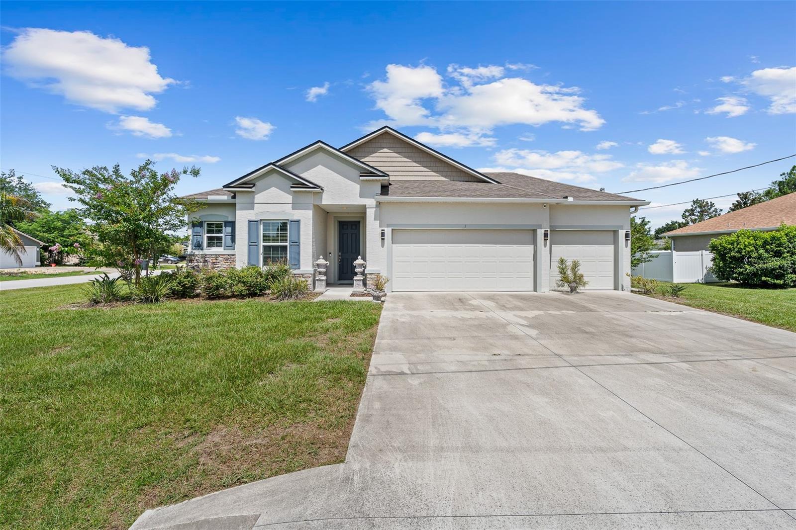 Built in 2020 and nestled on a prime corner lot at the end of a quiet cul-de-sac street, this stunning contemporary turn-key residence offers the ultimate blend of modern luxury and functional design. The light-filled, open-concept floor plan features beautiful wood-look tile flooring, crown molding, and soaring ceilings. At the heart of the home is a chef’s kitchen equipped with premium dark cabinetry, striking quartz countertops, an oversized central island with breakfast bar seating, stainless steel appliances, and a stylish mosaic tile backsplash. The kitchen flows effortlessly into the spacious living and dining areas, making it an entertainer's dream. Retreat to the luxurious primary suite showcasing a sophisticated double-tray ceiling and a spa-like ensuite with a massive, professionally designed custom walk-in closet system. Bring all your toys, as this 3-car garage gives ample room for storage or a workout space. Enjoy the best of Florida living on the sprawling, fully screened lanai that opens up to a massive, beautifully manicured backyard that is partially fenced and boasts plenty of room for a future pool. Conveniently located in Matanzas Woods, with easy access to I-95. Schedule your showing today!