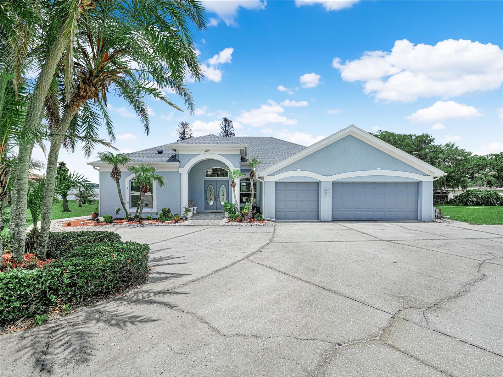 New to the market: A waterfront beauty on Lake Juliana. This 1.18-acre property sits on the public 924-acre Lake Juliana, a haven for boating, fishing, and those picture-perfect sunsets. Perfect for entertaining, the property opens with a long circular driveway that welcomes a crowd and makes parking a breeze. Inside, a double foyer leads to bright, connected living and dining spaces. At the heart of the home, the family room centers on a wood-burning fireplace flanked by windows with lake views. Sliding glass doors open to a large screened lanai, extending the living space outdoors for year-round entertaining. The kitchen features a snack bar with extra seating, a closet pantry, and all appliances. The dinette offers lake views to start your mornings right. The quiet sanctuary is the main suite, featuring an en-suite bath with a garden tub, double sinks, and a walk-in shower, plus closets and private access to the lanai. Two guest baths serve additional bedrooms: the second bedroom with its own bath, and a third bedroom with a full bath that includes a door to the outside—perfect for post-lake rinsing. The expansive screened lanai invites guests to mingle outdoors, with ample room for gatherings.  Additional notes: Boat dock present (requires some work) but has space for a boat and is covered. Scenic sunsets over Lake Juliana from multiple rooms and the lanai. Ideal lake lifestyle with easy access for boating, fishing, and waterfront relaxation Note: Well for irrigation. Septic tank is on right side of house when facing house. Call now for details and to schedule a private tour.