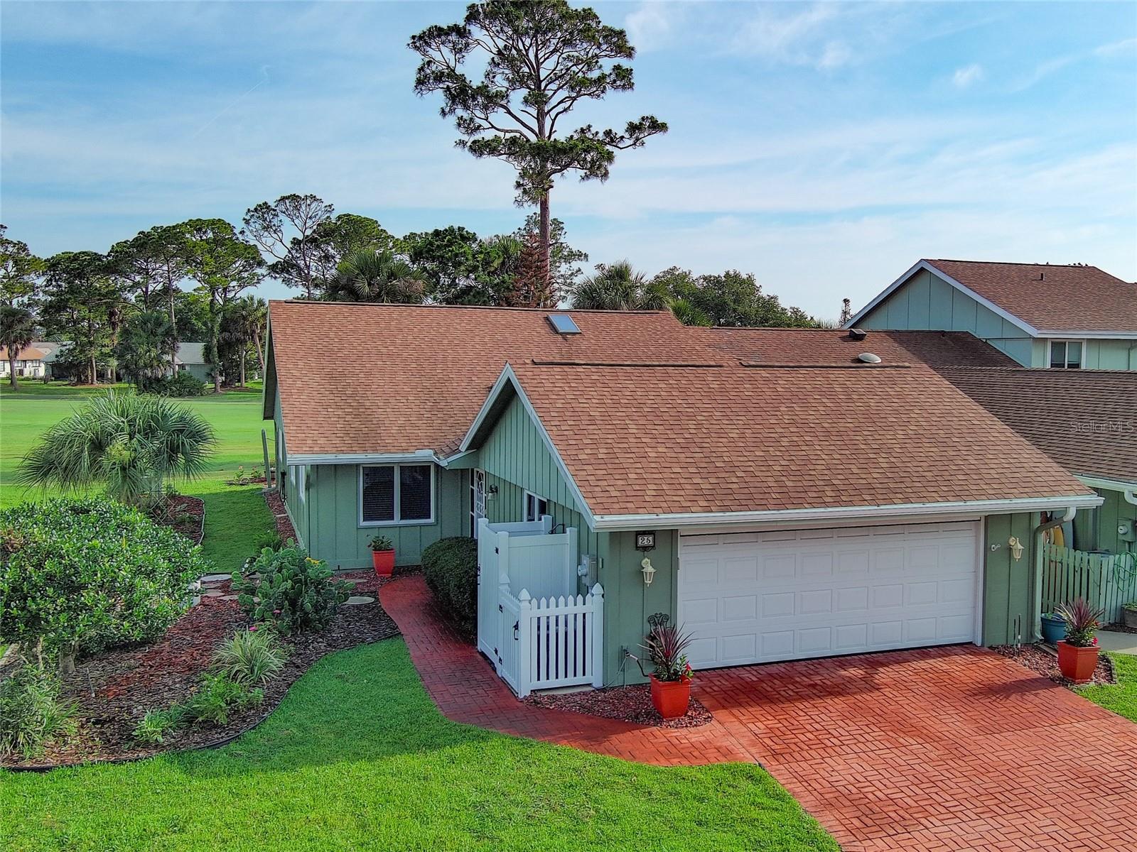 Hard-to-find One-Story 3 Bedroom Corner Unit awaits the discriminating buyer. Beautifully UPDATED and maintained home is ready to move in and start enjoying the Florida lifestyle. Open Kitchen flows into spacious living area, making it the heart of the home where friends and family gather. Hard-Surface counter tops, breakfast bar, large pantry, and newer appliances will please the most demanding chef, including 2026 refrigerator with 5 year warranty. This home covers all the big-ticket-items, with STORM RATED WINDOWS, NEW ROOF 2020 and NEW AC SYSTEM February, 2026. Garage door is storm rated to 140 mph, with 2026 Electric Screen Door. Enjoy expansive views of the fairways, from your golf-front family room and rear patio on the 3rd fairway of Hidden Lakes Golf Course. Private outdoor shower with hot & cold water will get the sand off the family's feet after visiting the nearby beaches of New Smyrna. Bright and light is the best way to describe this home, with lots of natural light, as well as sun tunnels. Enjoy the entry screened porch that affords you a private outdoor space to enjoy a good book.   Home was not affected and did not flood during 2022's amazing 1000-year-rated storm, Hurricane Ian. Low HOA annual dues of $360 provide you with sprinkler system and irrigation water, as well as termite bond. Nestled between 2 golf courses, in this golf cart friendly community that also offers a community pool, by separate and optional membership. The beaches are but a short car ride away, as is eclectic Flagler Avenue's shops and restaurants, or ride your bike to the Historic Canal Street Business District with all its restaurants, pubs, art galleries, and shopping, as well as weekly Farmer's Market and monthly Car Show. Great, central location is close to everything! Furnishings are negotiable.