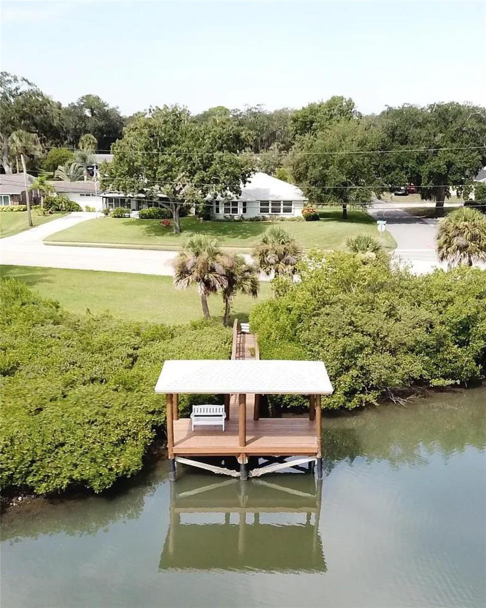 Riverfront home in downtown New Smyrna Beach, on a property that spans from Magnolia Street to the river. This home offers 2153 sq. ft. of living space, consisting of 3 bedrooms, and 2 bathrooms. Additional features include a shed with electricity, hurricane shutters, automatic roll-down garage door screening, a security system, natural gas water heater, heating, and home generator, double pane insulated windows, and a new roof in 2017. ;Water: City