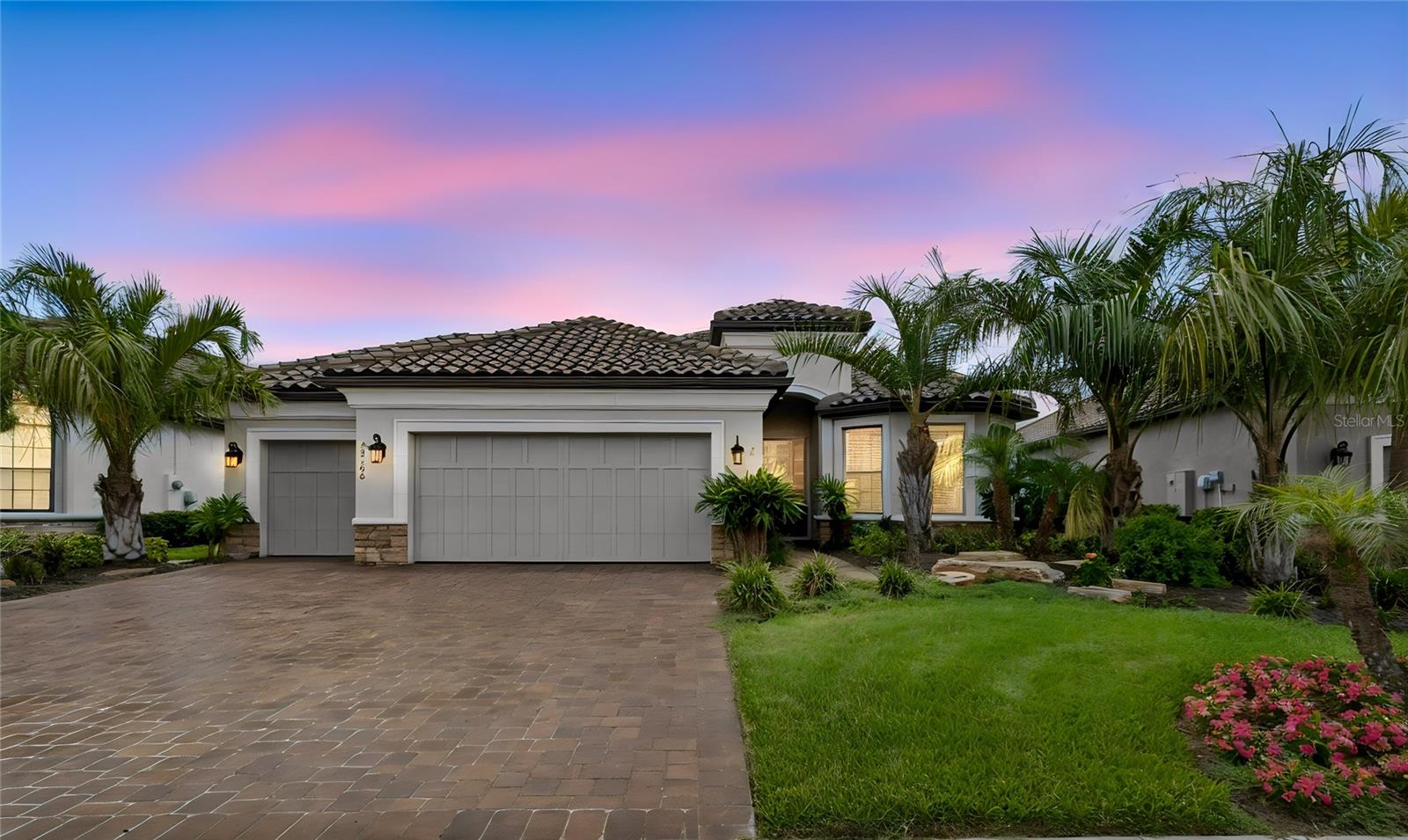 Virtually Staged. Why wait to build when you can enjoy this Lazio home featuring 2,401 SF, 3 bedrooms, 3 baths, an office/flex room, a 3-car extended garage on an oversized beautiful pond lot.  You will notice the attention to detail as you enter to an open floor plan, extended gourmet kitchen overlooking a large family room and dining room, featuring 42” solid wood cushion close cabinets with crown molding, quartz counters, under cabinet LED lighting, upgraded stainless steel appliances, enormous island, an ample walk-in pantry and extra counter space all designed for entertaining.  The owner’s oversized suite with tray ceiling and crown molding, dual sinks, tub, shower, a huge closet with custom built-ins, makeup counter, extensive custom bath tile and a linen closet. The family room boasts coffered ceilings with crown molding, and lots of natural light. Bedroom two has an ensuite bath and bedroom three has a bay window extension. Office/den has two walls of beautiful custom redwood built-ins shelves and cabinets. This one-story Taylor Morrison custom home has an open floor plan with an extensive list of upgrades. These upgrades include but are not limited to dining room, extended eat in kitchen, designer tile floors throughout in common areas, quartz counters and custom tile in baths, extended paver driveway, tile roof, large laundry room with cabinets, extended garage, 4 room stereo system with amplifier, extra refrigerator in garage, full sized 3rd car garage with separate door, water softener and an additional custom outdoor patio with fountain. Step out on to the covered screened lanai that is pre-plumbed for an outdoor kitchen and you will be ready to enjoy the Florida outdoors the premium pond lot boasts custom landscaping by a landscape designer. Esplanade of Wiregrass Ranch has a luxurious upscale club house with full-time lifestyle and fitness directors. The Venue includes a resort style pool, hot tub, cabanas, dog park, state-of-the-art 24-hour fitness center, billiard/card room, and spa room. For active outdoor entertainment there is a firepit, tennis, pickleball, bocci, and a large meeting/gathering area.  Esplanade also includes worry free yard maintenance, reclaimed water, Spectrum TV and internet package included in fees. This home is located only minutes from shopping, I-75, hospitals, restaurants, recreation, and entertainment.  Come see for yourself this beautiful residence and relax, you have found your home. Please see walkthrough and 3D tours.
