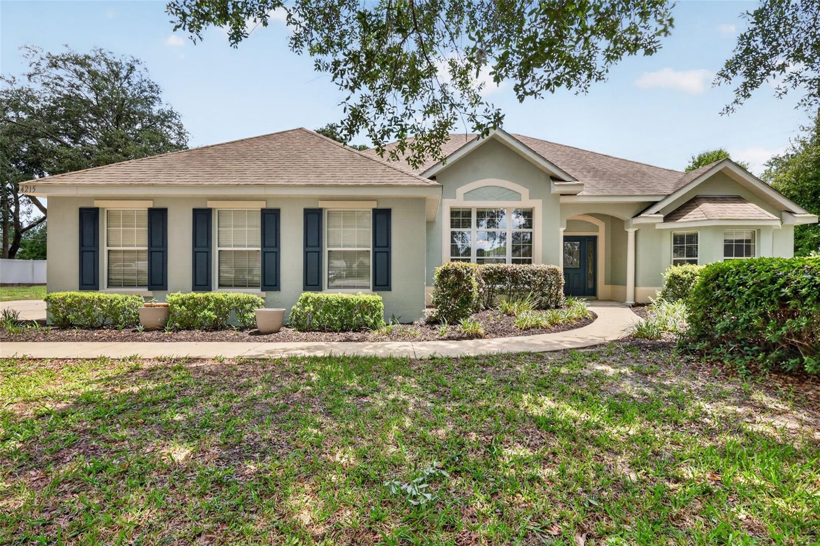 What a great place to call home in this Beautiful Pool Paradise 4-bedroom, 2-bath home. HVAC updated in 2023; new roof to be installed before closing. You will enjoy this open floor plan with a formal dining room. This large kitchen has wood cabinets, a large pantry, stainless steel appliances, a built-in microwave, and a large closet pantry. The breakfast nook area is shared with the kitchen area. The large master bedroom suite has a tray ceiling with accent lights. The master bathroom has dual vanities, with his and her walk-in closets, a garden tub bath, and a separate shower. In this home, you will enjoy the privacy of the split bedroom plan and the guest bath. The laundry/utility room has a laundry sink with cabinets for storage. In this pool home, you have a large backyard that is partially fenced in with chain link fencing. With the side-facing garage, you have a large concrete parking pad.  Come and enjoy a great location and a beautiful, well-maintained home. In this location, this puts you close to the amenities of The Villages