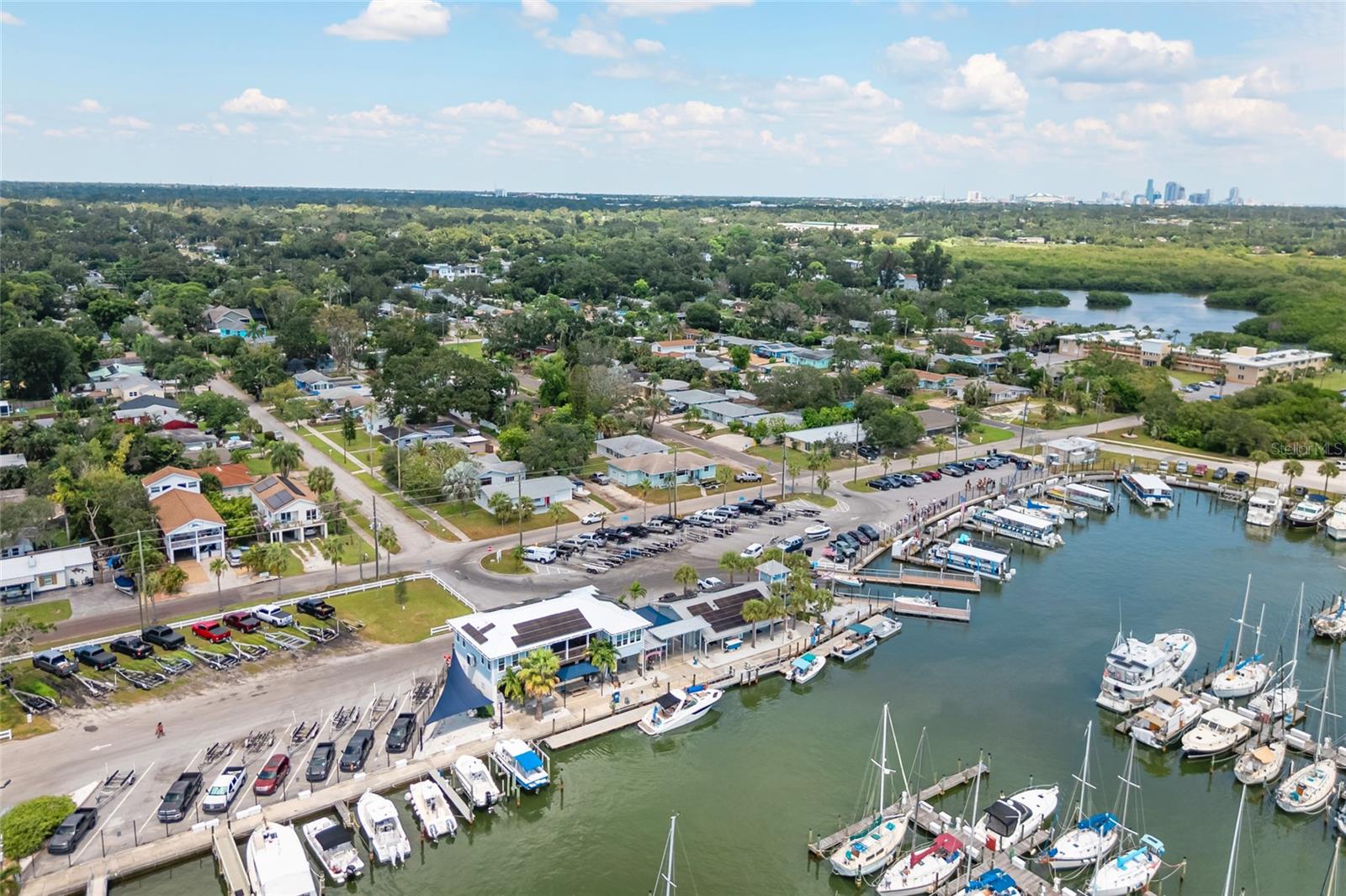 This home is steps away from the WATERFRONT and MARINA and Park with Kayak Launch.  Alley for easy access and room for RV, Boat, Waverunner and the rest of the toys.  LIKE NEW.  Renovated in 2025. This home has it all:  SOLAR Duke Energy bill approx. $30/mo.  IN-LAW SUITE + Bonus ROOM + 2 BR's + 2 Full Baths + HUGE DECK with electric for Swim/Spa, Spa, and GARAGE with workshop.  Walk to, PARK, SUNSET, TENNIS, and PICKLEBALL. GOLF CART to Downtown Gulfport, Casino, Entertainment, Shops, Restaurants, Tiki Bars, Tennis, and Beach. COMPLETE RENOVATION INCLUDES: Freshly painted inside and out. New FLOORS, New KITCHEN, New BATHROOM, New LARGE CLOSETS with Organizers, FIREPLACE, TREX Front Porch, Gutters, Electric Box and Wiring and so much more...All new! Looks and feels like a NEW HOME. NO HOA; NO EXTRA FEES. RENTALS ALLOWED.  Golf Cart to Downtown or Bike over to the Bike Trail. Vacant, cleared lot next door will be subdivided or available for sale. New Furniture and decor may be purchased separately or purchased turnkey for you or your tenants to take residency immediately.  Beatifully and professionally renovated.  LOCATION LOCATION, LOCATIONL