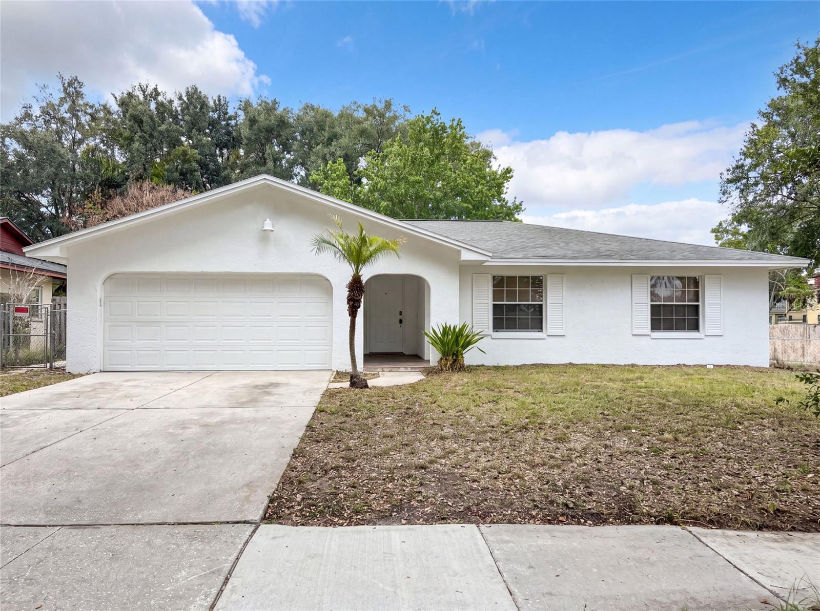 Virtually Staged. 2401 Myakka Dr is a 1-story Orlando single-family home built in 1990 with 3 bedrooms, 2 bathrooms, and 1,331 square feet. The kitchen includes white cabinetry, a range, and a ventilation hood, opening to a main living and dining area with tile flooring throughout. The primary bathroom features floor-to-ceiling marble tile, a soaking tub, and a shower, while the second bathroom offers tile walls and a tub-shower combination. A covered screened patio extends the living space to the fully fenced backyard with a green lawn. An attached 2-car garage completes this well-maintained single-story residence.. Included 100-Day Home Warranty with buyer activation