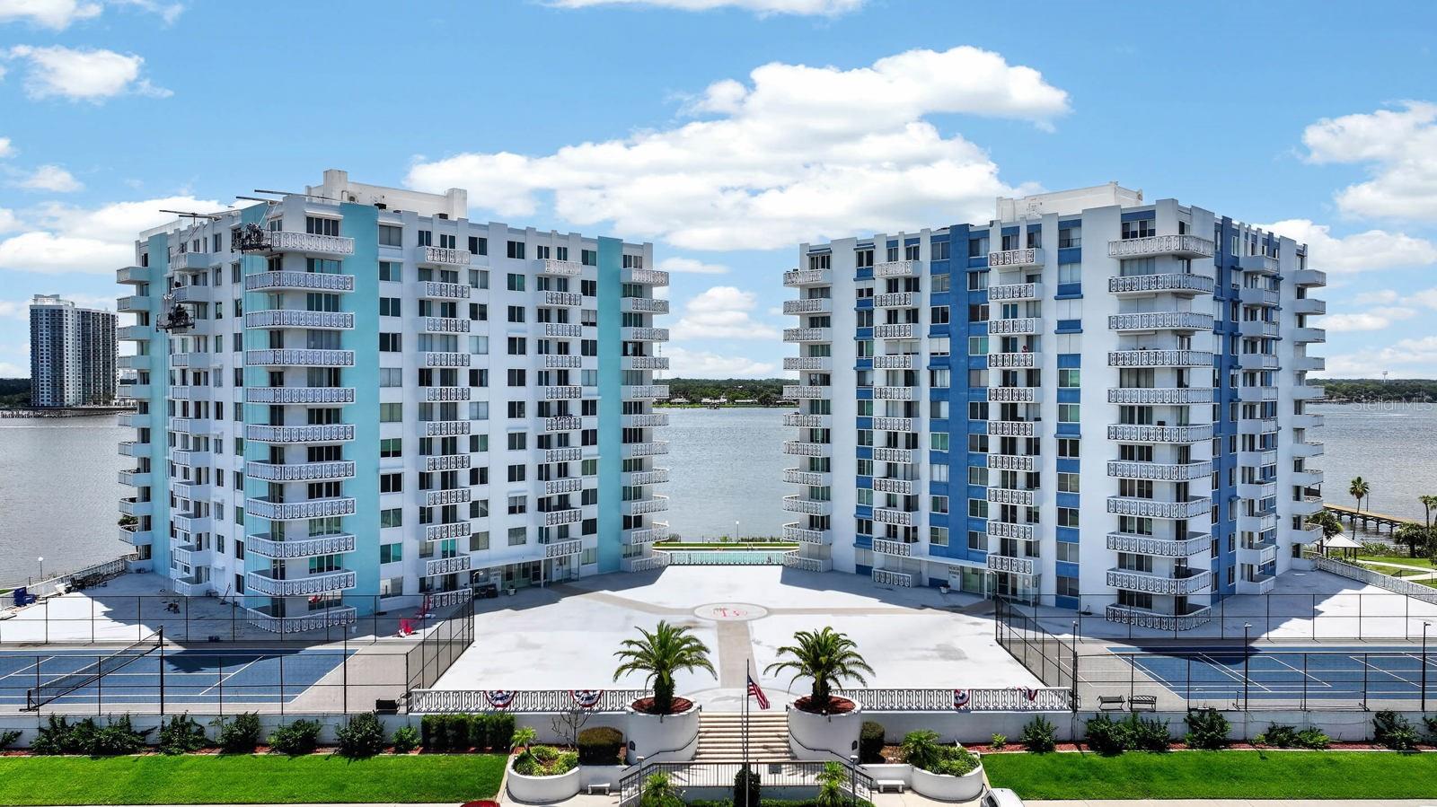 Wake up to spectacular Halifax River views and embrace the waterfront lifestyle you've been dreaming of! This beautifully updated, fully furnished 2-bedroom, 2-bath corner residence in the highly desirable South Building at Bayshore Bath & Tennis Club offers an exceptional combination of luxury, comfort, and resort-style amenities. Rarely available, this light-filled corner unit features a spacious wraparound balcony where you'll enjoy breathtaking sunsets, endless river breezes, and front-row seats to dolphins playing, boats cruising by, and the beauty of Florida living every single day. Inside, you'll discover a thoughtfully updated interior featuring a gorgeous kitchen with white shaker cabinetry, granite countertops, breakfast bar seating, abundant storage, updated flooring, upgraded windows and sliding glass door, hurricane shutters, and an inviting coastal design that is completely move-in ready. The spacious split-bedroom floor plan offers privacy for owners and guests, while the oversized primary suite features generous closet space and an updated en-suite bath. Additional conveniences include secure deeded underground parking and the option to continue leasing a private storage unit for a nominal monthly fee.  The lifestyle is what truly sets Bayshore apart. Residents enjoy one of Daytona Beach's finest amenity packages, including an oversized heated pool overlooking the Halifax River, a private community dock, tennis and pickleball courts, shuffleboard, fitness center with dedicated weight and cardio rooms, men's and women's saunas, billiards room, card room, library, game room, and an elegant social room where neighbors become friends. Located just minutes from the beach, restaurants, shopping, golf, and medical facilities, you'll enjoy the perfect blend of peaceful waterfront living and everyday convenience.  Opportunities like this don't come along often. Schedule your private showing today and experience why Bayshore Bath & Tennis Club remains one of Daytona Beach's most sought-after riverfront communities.