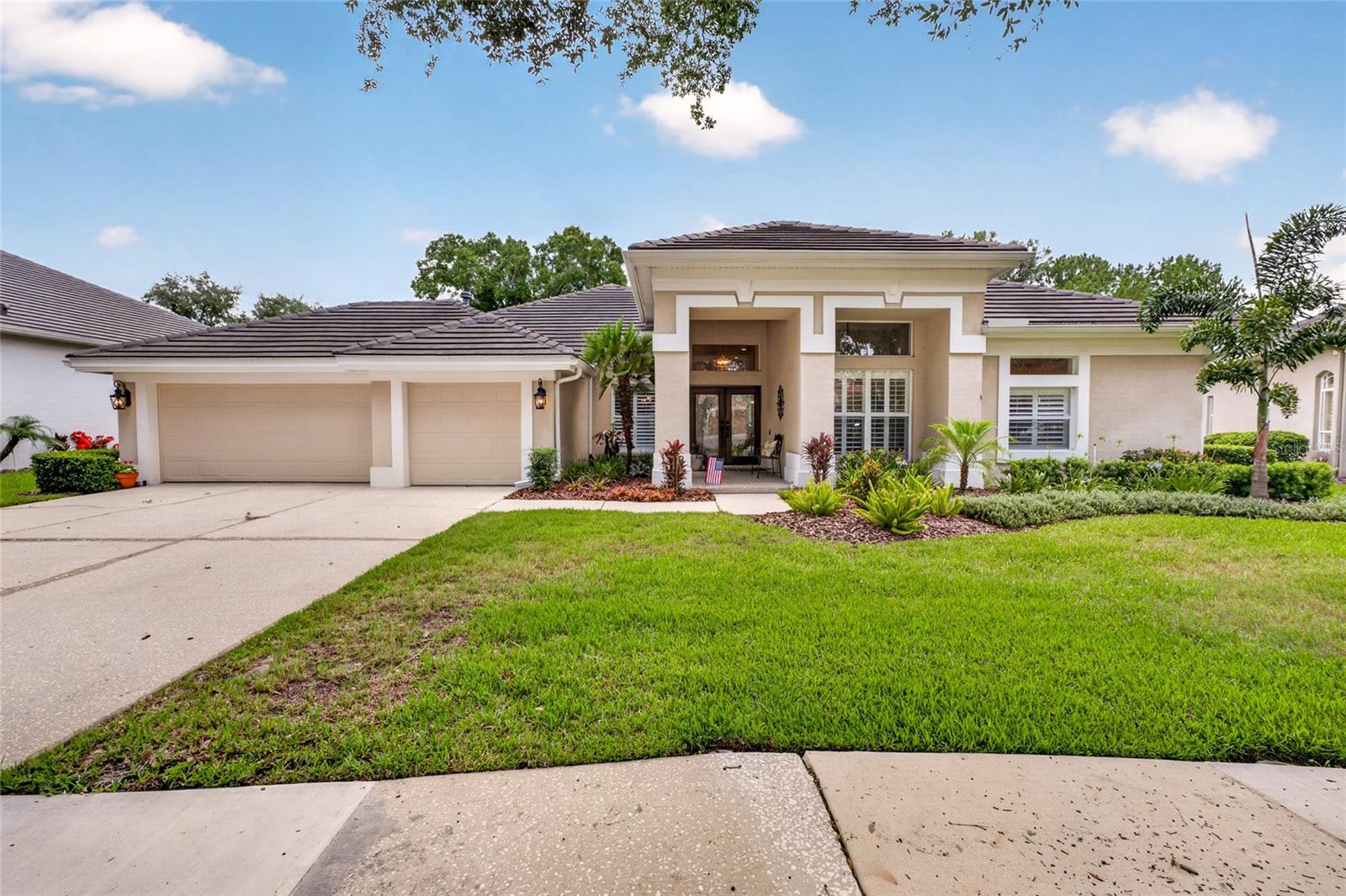 Welcome to 9109 Woodridge Run Drive, a beautifully updated 4-bedroom home plus dedicated office, perfectly positioned on the coveted 16th tee box in guard-gated Hunter's Green. Mahogany and hurricane glass doors welcome you into light, bright interiors with gorgeous hardwood floors throughout the main living areas, primary suite, and office, all installed in 2013 alongside a full kitchen remodel.
The kitchen has been thoughtfully upgraded with GE Monogram appliances, a Bosch dishwasher, 6-burner gas range, industrial-grade hood, built-in microwave drawer, wine fridge, and a 2-tier center island with eat-in seating, all designed for both everyday living and serious entertaining. The kitchen opens naturally to the family room, where a cozy gas fireplace with travertine ledge tile, flanked by built-in bookshelves, creates a warm, welcoming gathering space. Elegant plantation shutters add a polished, custom touch throughout the home.
This spacious floor plan offers a generously sized combined living and dining room, a separate family room, and a dedicated office. Bathrooms were renovated in 2021 and 2024, with a powder room and separate pool bath for effortless indoor-outdoor entertaining. A 3-car garage completes the home.
Major systems have been meticulously updated, including a new A/C system (2019), new roof (2020), tankless water heater (2020), and WiFi-enabled thermostat (2026).
Step outside to a remodeled pool and paver deck (2021) and a large covered lanai overlooking sweeping views of the 16th tee, one of the most desirable lots in the community. Fresh landscaping (2020) with outdoor lighting adds privacy and evening ambiance.
Move-in ready and meticulously maintained, this home checks every box for buyers seeking space, style, and an unbeatable location in one of New Tampa's most sought-after communities.
Hunter's Green is a premier guard-gated community in New Tampa, known for its mature oak canopy, winding sidewalks, and 24-hour manned gate security. At its heart is the private Hunter's Green Country Club, offering an 18-hole championship golf course, tennis and pickleball courts, resort-style pool, and full dining, available through optional membership. The community also features miles of walking and biking trails, parks, and a true neighborhood feel that's increasingly rare this close to the city.
Residents enjoy quick access to top-rated schools, USF, Moffitt Cancer Center, and Advent Health, plus the ever-expanding shopping and dining along Bruce B. Downs and Cross Creek Boulevards. With easy connections to I-75 and I-275, downtown Tampa, Tampa International Airport, and the Gulf beaches are all within convenient reach, while the tree-lined streets of Hunter's Green offer a quiet, established retreat at the end of the day.
Don't miss this opportunity to own a move-in ready home on one of Hunter's Green's most scenic and coveted lots.