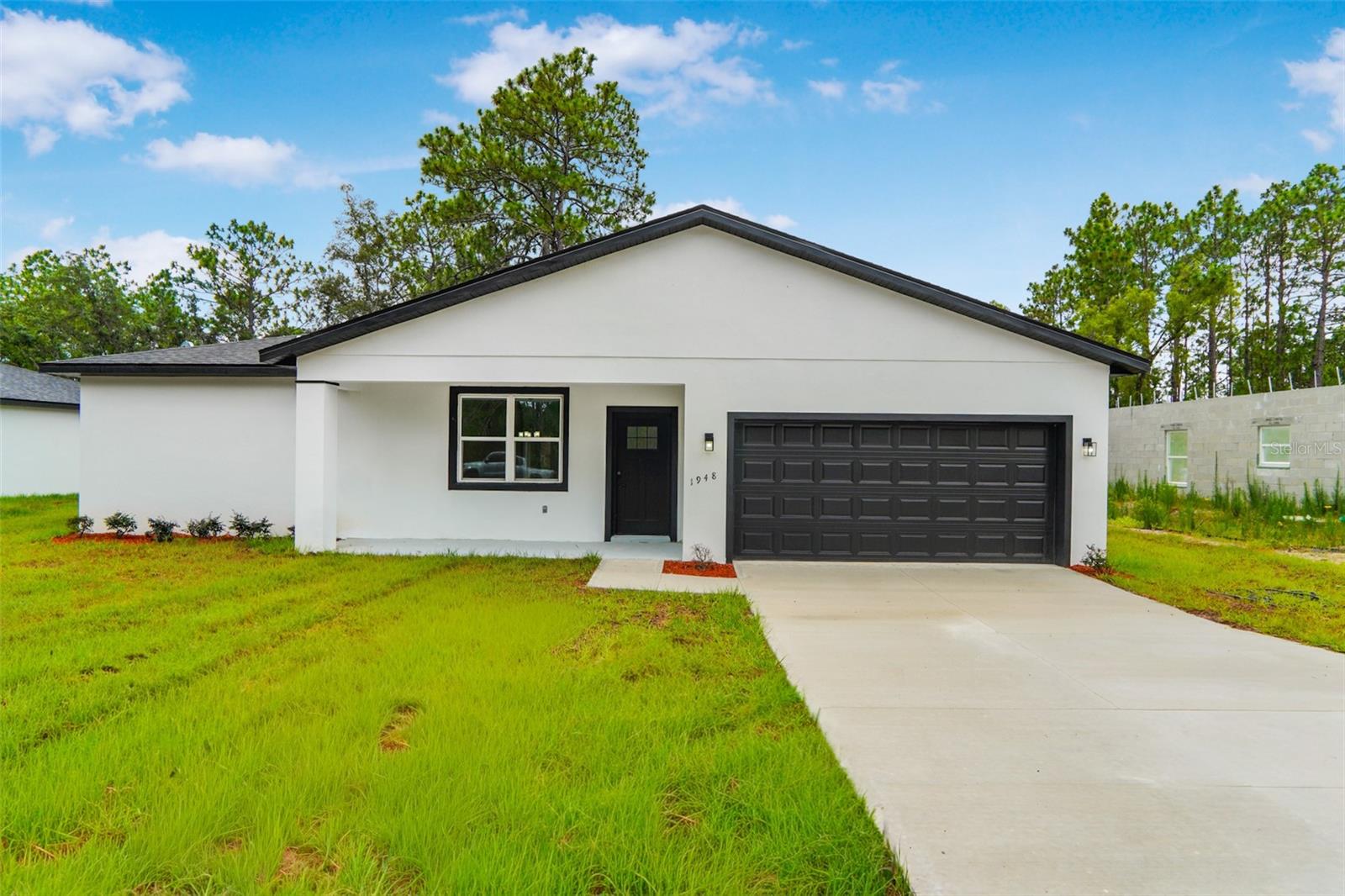 Brand-new 2026 build in Citrus Springs, never lived in — be its very first story. This 4-bed/2-bath single-story offers 1,845 sq ft of open-concept living: porcelain tile + SPC luxury vinyl, Luna Pearl granite with a waterfall island, solid-wood shaker cabinets, a freestanding soaking tub, and stainless Whirlpool appliances fresh out of the box. Block/stucco construction, shingle roof, 2-car garage, paver driveway, 0.22-acre lot, and — bonus — no HOA, plus a 1-year builder warranty for true peace of mind. Live minutes from the Rainbow River and Rainbow Springs, the Withlacoochee State Trail, and Citrus Springs golf, with Ocala and the World Equestrian Center about 35 minutes away. USDA-eligible — full financing, zero down — a rare shot at a brand-new home with nothing down. Be the first.