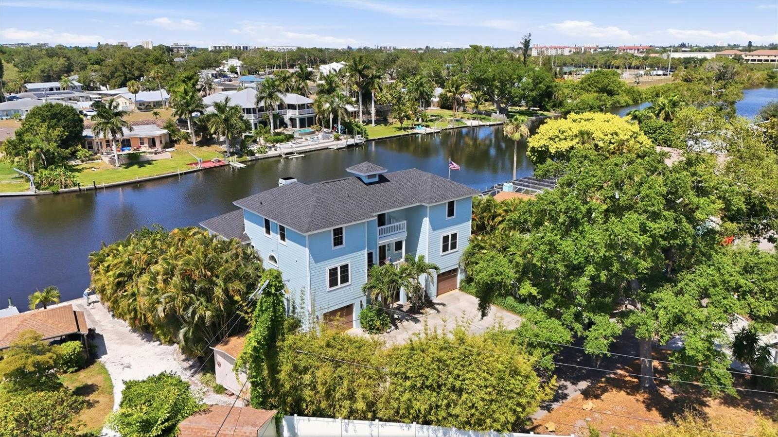 You’ll love entertaining guests and embracing the tranquility of waterfront living in this one-of-a-kind classic Key West home on Philippi Creek Bayou. Enter through mahogany doors to soaring cathedral ceilings that fill the home with natural light and create an open, airy atmosphere. Expansive water views can be enjoyed in most rooms, while the outdoor deck provides the perfect setting to relax and take in stunning sunset skies. Inside, the Key West coral fireplace, luxury vinyl plank flooring and thoughtful architectural details create warmth and character throughout. The kitchen is designed for gathering and entertaining, featuring stainless steel appliances, a stainless-steel chef’s cooking area, quartz countertops and a wraparound bar that encourages memorable moments with family and friends. The enormous primary suite serves as a private retreat with its own water-view balcony, charming gas fireplace and bay windows. The spa-inspired en suite bath offers dual vanities and a relaxing spa tub. Dedicated office space provides flexibility for working from home or creating a quiet study area for the kids. Upstairs, you’ll find four bedrooms, a balcony and two full baths. The lower level features an expansive entertaining area ideal for a growing family, game room, gym or play space, along with a convenient pool bath for hosting guests. Outside, enjoy the private open pool area positioned at the water’s edge with long, peaceful canal views. The waterfront lifestyle continues with a kayak launch, Jet Ski floats and a newer composite boat dock with a 13,000-pound lift ready for boating adventures. Adding even more appeal for boating enthusiasts, the county is currently dredging the canal to further improve water access and navigation. The home has also been thoughtfully updated with a newer roof and freshly repainted interior and the property has been well maintained with no known storm-related damage or water intrusion. Just minutes from Philippi Shores Elementary and Riverview High School, this exceptional property is ideal for a growing family that loves the outdoors. A treasured Suncoast oasis where privacy, comfort and waterfront living come together beautifully.
