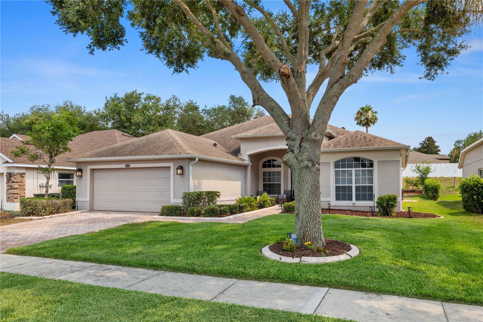 Stylish, Modern home with SOLAR PANELS (paid off), ROOF replaced (2019) creating a comfortable living environment.  1283 LEGENDARY is located in Legends Country Club – a GUARD and GATED community with exclusive AMENITIES.  Step inside and you’ll quickly notice the elegant, curved archways, clean lines and modern feel - with abundant lighting providing a natural flow throughout living spaces. 3 Bedrooms and 3 Baths, with a 4th bedroom (no closet) well-suited for an office, guest space or flex room.  Beautiful kitchen features crisp white cabinetry, lots of counterspace, an extended breakfast bar, and spacious walk-in pantry—perfectly designed to keep the family chef connected with guests and everyday conversations. An ADDITIONAL 114 sq ft. was added to the living area (2021).  The blend of wood and tile flooring provides beauty and effortless upkeep.  Enjoy your own retreat in your primary suite with French doors leading to the back patio.  The primary bath offers dual sinks, a walk-in shower and a relaxing garden tub – a perfect place to unwind.  The outdoors await – a versatile back patio overlooking your back yard, ideal for a cup of morning coffee, weekend gatherings, or peaceful evenings at home. As an added bonus, the solar panels (2021) are fully paid off, cutting your electric bill in half, adding savings and long-term value for years to come. ****** LEGENDS HOA INCLUDES fiber optic high-speed INTERNET and Cable TV + Residents benefit from exclusive amenities including a COMMUNITY POOL, Kiddie Pool, Hot Tub, SAUNA, FITNESS CENTER, Tennis/Pickleball and basketball courts, Tavern/Grille, Golf Pro Shop, Pool Table/Ping Pong, Community Kitchen and 10,000+sq ft. CLUBHOUSE that overlooks Lake Louisa! Prime location just minutes from Hwy 27, Hwy 50, FL Turnpike, dining, shopping, hospitals and schools within close proximity. Also, you’re a short drive to Disney World and all the Orlando attractions. An inviting, well-designed home that delivers comfort, style and efficiency! A HOME WORTH SEEING IN PERSON.