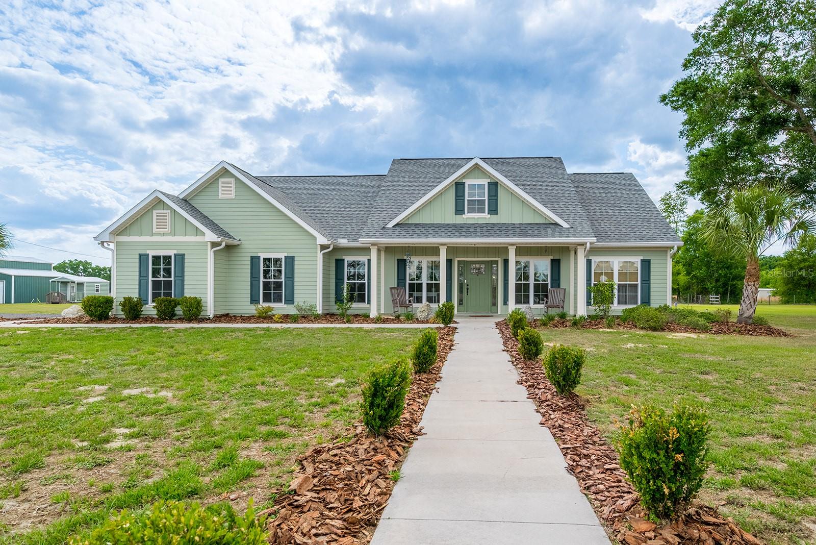 Discover the perfect blend of privacy, space, and functionality with this 3 bedroom, 2 bathroom home on 5 acres in Trenton. The property is tucked behind a gated entrance and is fully fenced, offering an ideal setting for a mini farm, homestead, or private country retreat in North Florida. Inside, the home features an open-concept floor plan designed for both everyday living and entertaining. The spacious kitchen offers abundant storage, making it both functional and inviting. The home is also equipped with a whole-house generator connected to a 1,000-gallon buried gas tank, providing reliable backup power and added peace of mind. The exterior of the property is well-equipped with improvements that add both value and versatility. There is a large pole barn that is perfect for storing equipment, RVs, or boats. In addition, the detached three-bay garage provides excellent space for vehicles, a workshop, or hobby use. Three additional storage sheds are located on the property, and all outbuildings have power already run to them. The property also includes two wells, offering added flexibility for agricultural use or irrigation. Located in Gilchrist County, this home provides a quiet rural lifestyle while still being conveniently close to nearby amenities. It is just minutes from downtown Trenton, where you will find local shops, restaurants, and schools. The property is also a short drive to Newberry and Gainesville, offering additional dining, shopping, and medical facilities. For outdoor enthusiasts, the location is ideal. The home is near the Suwannee River and the Santa Fe River, as well as several natural springs that are known for boating, fishing, kayaking, and other recreational activities. This property offers a rare opportunity to own a well-equipped home with acreage, outbuildings, and modern conveniences in a desirable North Florida location.