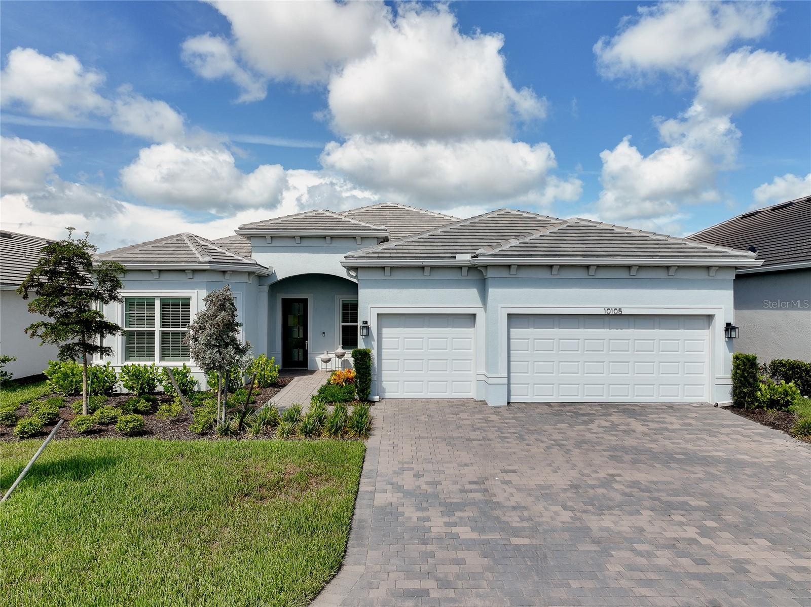 Welcome to 10105 Beachwalk Drive in the highly sought-after BEACHWALK by Manasota Key, a stunning estate home that is only 18 months old and truly BETTER THAN NEW, with an extraordinary collection of luxury upgrades already completed for the next owner. Perfectly positioned to capture breathtaking WATER VIEWS and unforgettable Florida SUNSETS, this exceptional residence offers the ideal blend of sophistication, comfort, and modern convenience.

Featuring the highly desirable STELLAR floor plan with 2,483 square feet of interior living space, this thoughtfully designed home offers 3 BEDROOMS, a private study/DEN, 3 FULL BATHS, and a spacious 3-CAR GARAGE, providing ample room for storage, hobbies, or even a golf cart.

Inside, you'll find TILE FLOORING throughout the entire home, elegant TRAY CEILINGS in the great room and primary suite, beautiful CUSTOM WOOD ACCENT WALLS, designer lighting, upgraded ceiling fans, and high-end finishes throughout. The expansive ZERO-CORNER POCKET SLIDING DOORS create seamless indoor-outdoor living while showcasing the spectacular water views.

The EXECUTIVE KITCHEN features upgraded KITCHEN-AID APPLIANCES, GAS COOKING, WALL OVEN and microwave, an upgraded sink, QUARTZ COUNTERTOPS, a designer backsplash, and a spacious CUSTOM WALK-IN PANTRY. Additional premium features include a REVERSE OSMOSIS drinking water system and a whole-house WATER SOFTENER.

The PRIMARY SUITE offers a CUSTOM WALK-IN CLOSET organization system, while the laundry room includes upgraded cabinetry, sink and storage. PLANTATION SHUTTERS, custom slider window treatments, and premium window coverings provide both elegance and privacy.

Step outside to your private oasis featuring a HEATED POOL AND SPA, motorized HURRICANE SCREENS, decorative lanai lighting, and an outdoor kitchen pre-plumb.

The 3-CAR GARAGE boasts EPOXY FLOORING, a dedicated AC MINI-SPLIT SYSTEM, a WHOLE-HOUSE SURGE PROTECTOR including pool heater protection, and abundant storage space. Upgraded IMPACT WINDOWS AND DOORS throughout provide exceptional storm protection, energy efficiency, and peace of mind.

This is a rare opportunity to own a better than new, extensively upgraded luxury home in one of Englewood's premier resort-style communities—without the wait for new construction.  Most builder WARRANTIES for this home are still TRANSFERABLE to the new owner and SAVE ON THE CAPITAL CONTRIBUTION compared to a new build!

BEACHWALK offers a resort-style pool with lap lanes, fitness center, café, tiki bar, fire pits, 10 pickleball courts, 5 tennis courts, 6 bocce courts, a dog park, community garden, and more, all with NO CDD FEES. Future plans include a formal restaurant in 2027 and a new 13,000-square-foot amenities center featuring a game room, golf simulator, auditorium, demonstration kitchen, and expansive covered gathering space.

Located just 2.5 miles from Manasota Beach, this exceptional home offers the very best of Florida's Gulf Coast lifestyle every day.
