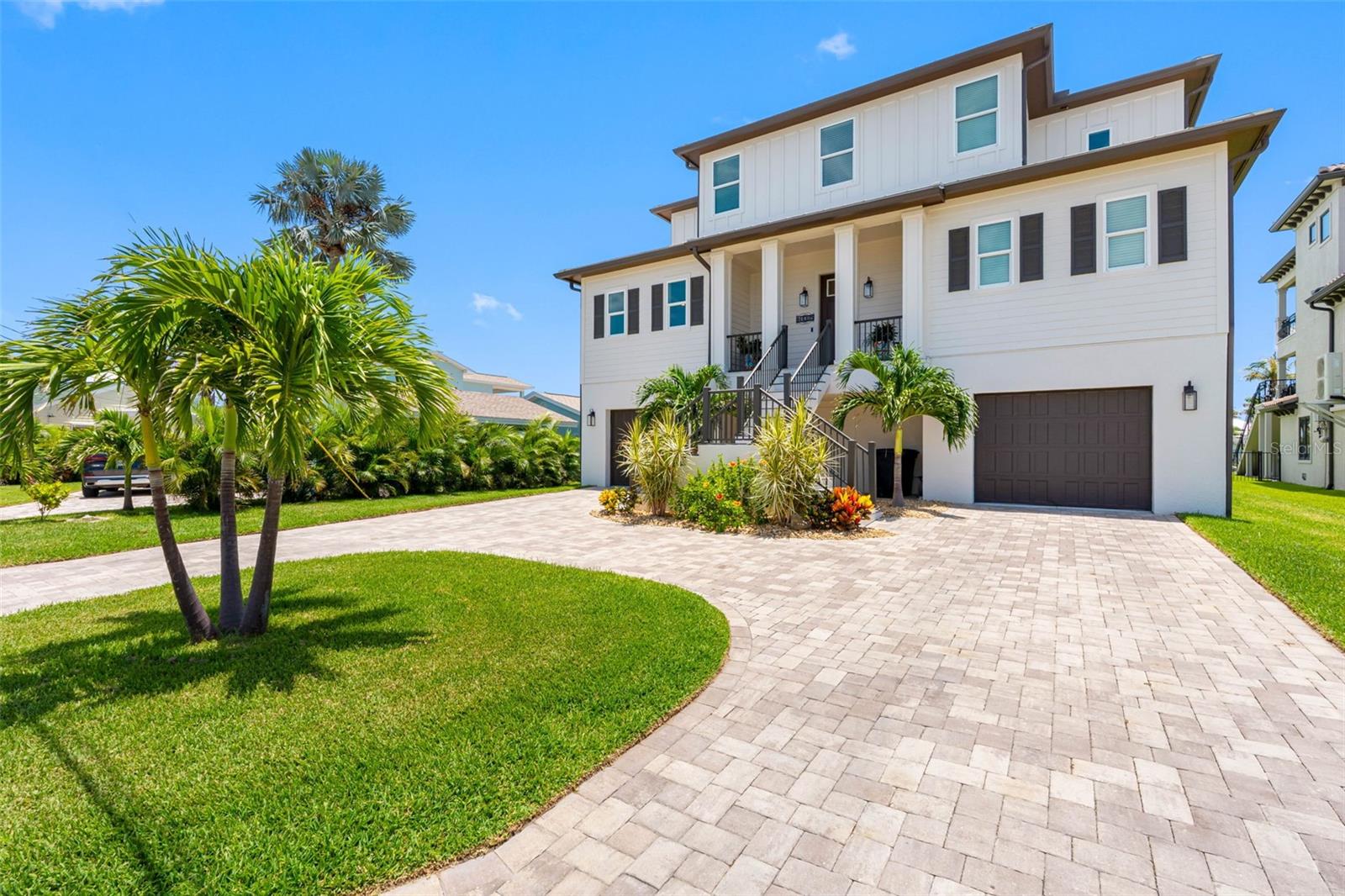 Redington Beach, a coveted small beachside community, with sublime white sand beaches, resident only beach parking
and a local friendly vibe is the place to be on the Gulf coast. This custom home built in 2023,
encompasses the true Florida lifestyle. Situated on a large waterfront lot with room for an
enormous pool and outdoor space, you’ll press the 10,000 lb boat lift button and be in the
Intracoastal Waterway in minutes. Drop in a jet ski and head out to explore the spoil islands.
Sunrise and sunset views are available for your daily enjoyment. When you get tired of the fun
and sun, head indoors to the four bedroom and four and a half bathroom home with a garage
that holds four cars and plenty of storage for the toys. From the garage, you can access all
floors of the home by elevator making easy work of groceries, and providing accessibility for
those who might require it. The first main living level bestows the light filled, high ceiling, airy,
open concept. In the kitchen, a gorgeous eight burner gas range and Forno appliance suite is
giving executive chef. The walk in pantry with coffee bar will make those sunrise mornings a
joy. A large water front balcony opens up the living room and provides an inviting space for
boat parades, firework, holiday gatherings and sunset watching. The primary bedroom on this level
faces the waterfront, with a walk in closet, large bathroom and private commode room. A half
guest bath and laundry room on this level make this a very efficient, and yet private space.
Upstairs are three bedrooms with two having a full ensuite bathroom and the third bedroom
sharing a full bathroom as an additional guest bath. The central loft space would make a
perfect office, media room, home school space or study. Another large waterfront
balcony here truly make this the ultimate second floor getaway, perfect for kids or extended
family. Come live the real Florida lifestyle with manatees and dolphins at your dock, sunset
beach walks and fantastic restaurants and venues for music just a bike or golf cart ride away.