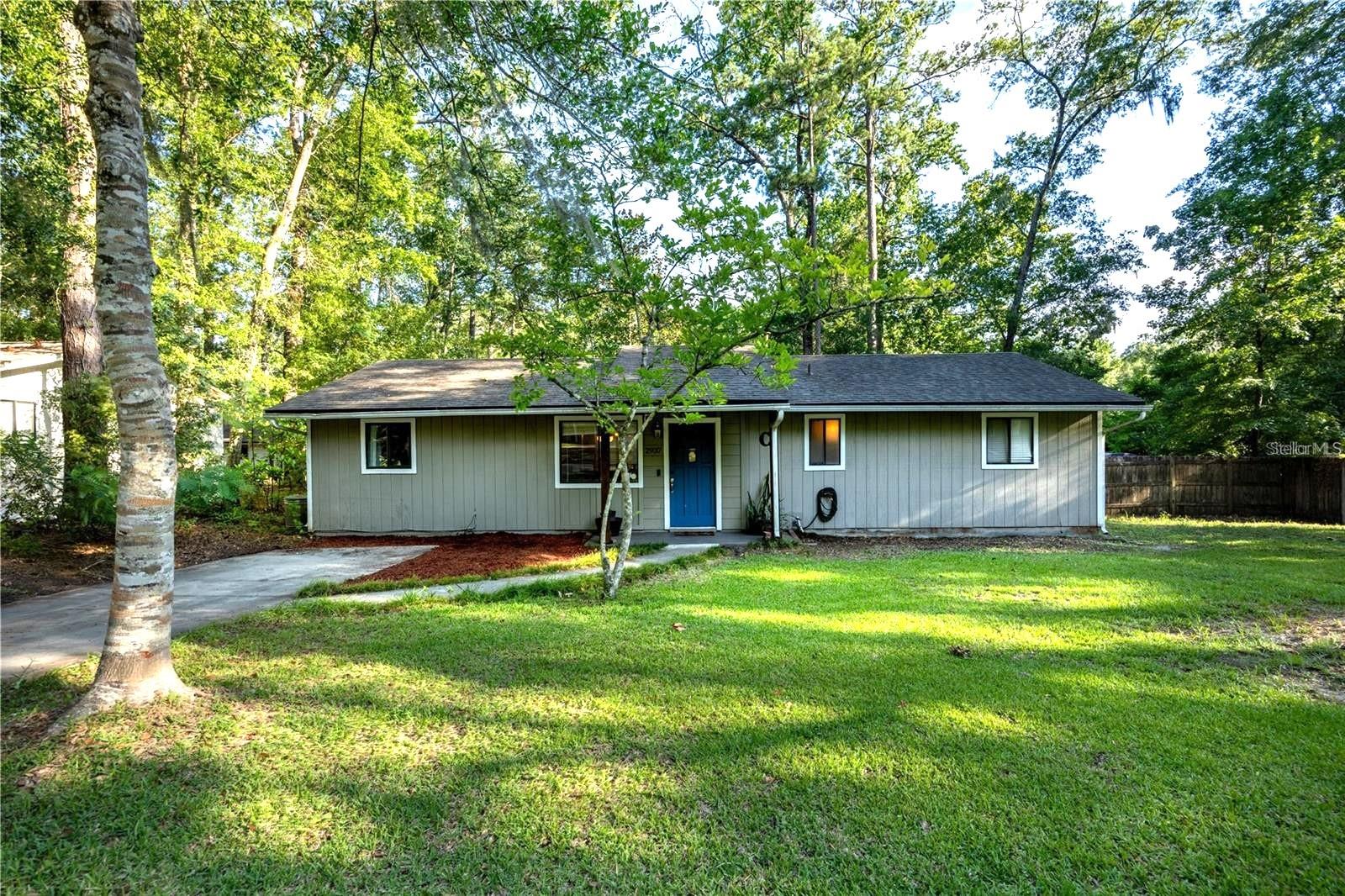 This charming home is tucked away on a quiet cul-de-sac in Gainesville's Springtree subdivision. With NO HOA, you will enjoy the updated kitchen and bathrooms and bright, open-concept floor plan. The interior showcases striking wood-look, ceramic tile flooring throughout, creating a warm and modern feel. The heart of the home is the updated kitchen, complete with granite countertops, a stylish tile backsplash, a large, granite center island, stainless steel appliances, reverse osmosis, and a gas stove-perfect for both everyday meals and entertaining. You will also enjoy two large spacious living areas that provide plenty of room to relax, spend time with family or entertain guests. Highlighted by modern lighting and a cozy whitewashed brick fireplace, one of the living spaces looks out onto a generous wood deck and fire pit- your private outdoor retreat for unwinding after a long day or grilling with friends. Just minutes from I-75, the University of Florida, Santa Fe College, and Shands Hospital this home combines comfort, style, and an unbeatable location!