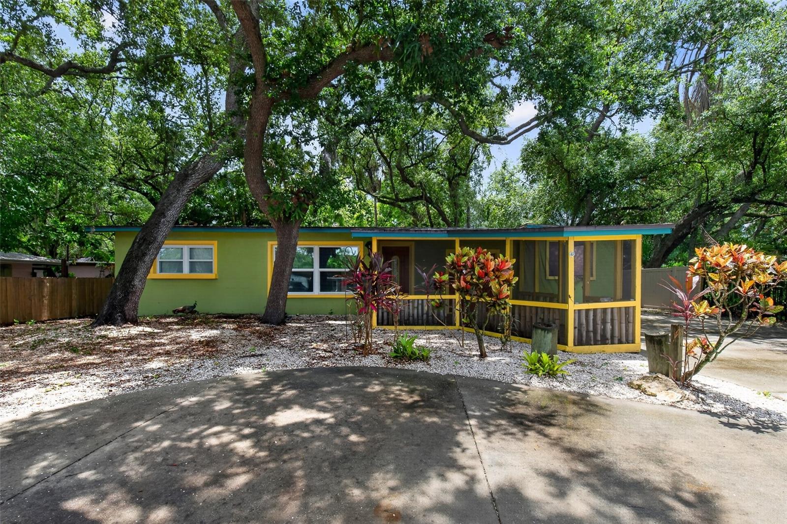 Welcome home to this uniquely charming 3 bedroom, 2 bath rental home, nestled within a serene, park-like setting that feels a world away while remaining just moments from shopping, dining, local parks, and the beautiful Gulf beaches. From its captivating character to its incredible versatility, this residence is truly a rare find. Your journey begins on the inviting, screened-in front porch—a perfect, breezy spot to enjoy your morning coffee or unwind while taking in the peaceful surroundings. Step inside to discover a warm, character-filled interior with a highly adaptable floor plan. Designed to effortlessly accommodate multi-generational living, the layout can easily configure to include an in-law suite. Further enhancing its unique utility, the versatile back room can serve as a private home office, an inspiring art studio, or be converted into a spacious fourth bedroom. The charm extends outdoors to a spacious, fully fenced backyard. Here, a large back deck overlooks the tree-lined, park-like views, offering an idyllic backdrop for quiet afternoons or outdoor entertaining. The property also boasts an abundance of parking, offering more than enough room for multiple vehicles, an RV, a trailer, or a boat. Combining its distinct warmth with modern convenience, the home also features a full-sized washer and dryer included for your ease. This property blends unique personality, incredible space, and unbeatable coastal proximity into one perfect package.
