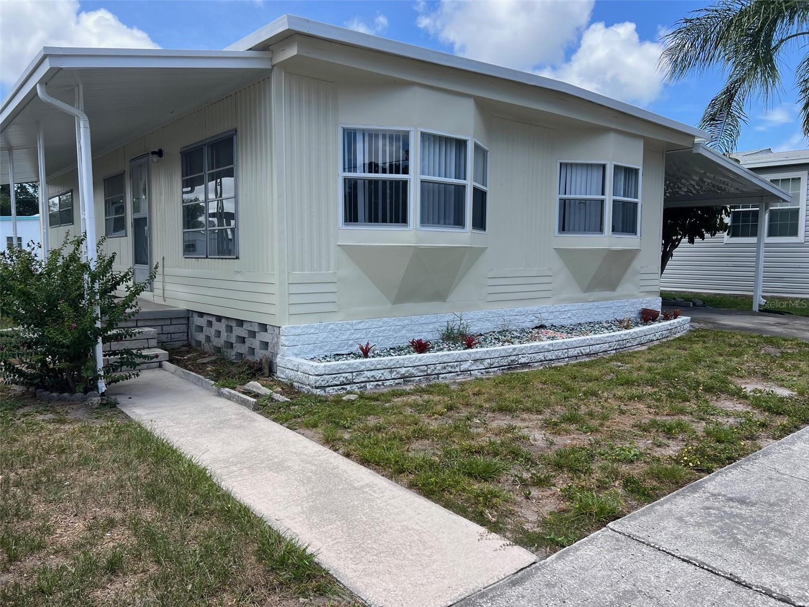 Discover your dream in this spectacular 55+ mobile home park perfectly situated on the shores of scenic Lake Seminole! As the proud winner of the prestigious Best of Largo Awards for mobile home parks in 2022, this lively community continuously delights residents by providing a sun-drenched environment that truly makes the Gulf Coast the absolute place to be. Living here is exceptionally stress-free thanks to a low $300.00 monthly maintenance fee that completely covers your water, sewer, garbage, and lawn care. The park boasts an array of resort-style amenities, including a sparkling pool complete with convenient showers and restrooms, active shuffleboard courts, two serene picnic areas outfitted with tropical Tiki Huts, a private boat ramp, and an entertaining billiard room. Best of all, you can enjoy endless days of premier boating and fishing right on the lake. Available right now is a fantastic 2-bedroom, 1.5-bathroom home featuring the added privacy of no front neighbors, making it the perfect time to move yourself right into paradise!
INTERIOR:
This fully furnished home is beautifully updated and ready to impress! Stepping inside, you will love the seamless laminate flooring running throughout, the cozy breeze from the ceiling fans, and the ideal climate controlled by central heat and air. Newly updated front windows flood the home with natural light, starting in the lovely dining room that is perfectly cozy for relaxed dining yet large enough to invite a few friends. Directly adjacent is the considerable living room, a sun-drenched and comfortable spot that is absolutely great for entertaining. The showstopping kitchen displays gorgeous new cabinets with new countertops and pristine new stainless-steel appliances—including a fridge, range, oven, dishwasher, and microwave. Storage here is incredibly plentiful and customized to perfection with a cabinet with pull-out shelving, a roll-out spice cabinet, a faux drop drawer at the sink for hiding away sponges and brushes, pull-out cabinets for garbage and recycling, and a clever corner cabinet with a door that opens to allow use of the entire cabinet -no useless space! Visitors and guests are serviced with ease by a beautiful full bath, which provides a single sink vanity, a sleek walk-in shower, and ample cabinets for storing towels, linens, and toiletries. When it is time to unwind, the considerable guest bedroom is wonderfully welcoming, light, and bright with plenty of closet space. Finally, the substantial master bedroom treats you to a few extra features that make it feel truly special, including a space filled with natural light, a generous walk-in closet, and its own private 1/2 bath ensuite!
EXTERIOR:
You will immediately notice the crisp curb appeal of the durable aluminum siding paired with a newly painted exterior, a brand-new carport, and a fresh new roof-over. The infrastructure is equally impressive, offering a new water heater and updated plumbing for ultimate worry-free living. Step inside to discover a spacious, lowered Florida room that is currently a total blank slate—your imagination is truly the limit on how you can make this fantastic space your very own! Just beyond the Florida room, a handy utility shed perfectly houses the washer and dryer, keeping laundry day wonderfully accessible and organized. Priced at an incredible price of $162,000 (including share), this  gem is a must-see that guarantees to elevate every day into a non-stop, sun-soaked vacation!