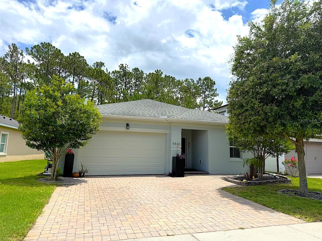 Spacious 4Bd, 2Ba, 2 car garage in Port Orange FL. One of the best values in the area in this move-in ready block home offering a clean open concept layout with tile flooring in the main living area.  The kitchen features deep countertops, stainless steel appliances, and a large island with breakfast bar seating, ample cabinetry, and pendant lighting.  Spacious living and dining areas.  The primary suite offers a tray ceiling, walk-in closets, and en-suite with dual vanities. Three additional bedrooms share a guest bath. Interior laundry room with garage access.  Enjoy outdoor living in the screened lanai.  Excellent curb appeal and low maintenance landscaping. Easy access to the Pavilion for shopping and dining.