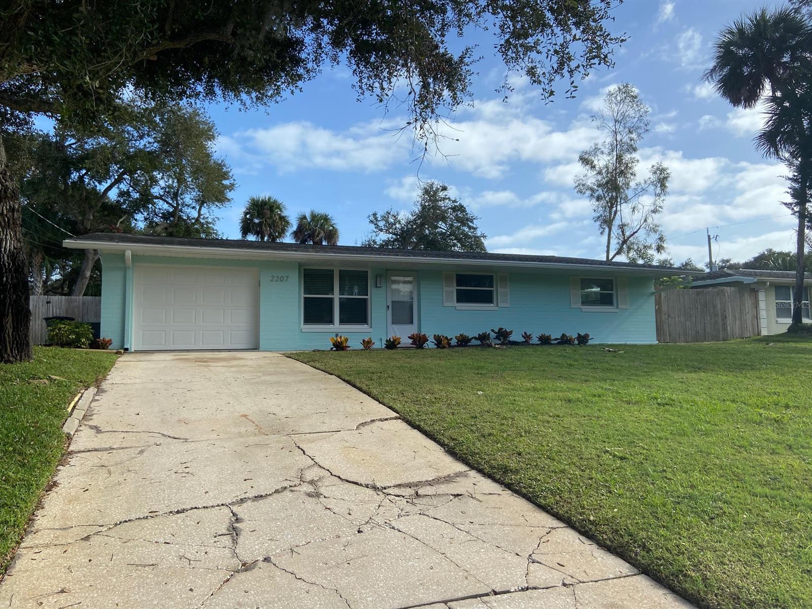 Beachside living at it's finest! Come live in this adorable beach side home with a fenced in yard and beautiful new sod and irrigation. Laundry room is nice and large with additional storage. Kitchen is updated looking out to the back yard with an eat in kitchen. Living room is large. Master bedroom has an en suite bathroom and a walk in closet. Bathrooms are updated with new sinks.