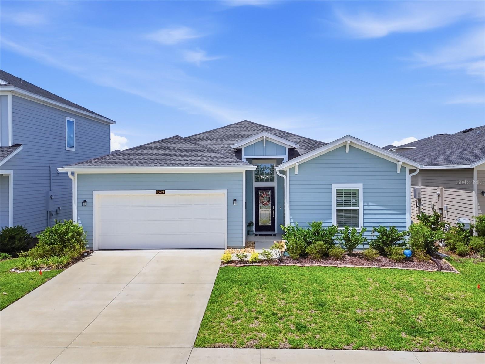 Better than new and loaded with upgrades, this 2024-built Lennar Trevi floorplan offers 4 bedrooms, 3 bathrooms, and 2,046 square feet of beautifully designed living space in the highly desirable Trailhead Landing community. Perfectly positioned directly across from the community pool, playground, and convenient neighborhood mailboxes, this move-in ready home delivers all the extras buyers want without the wait or added expense of new construction. Inside, you’ll love the bright open-concept layout featuring wood-look tile throughout the main living areas, upgraded lighting, plantation shutters throughout, and a spacious great room where the mounted TV and soundbar stay with the home. The kitchen is designed for entertaining with white cabinetry, quartz countertops, stainless steel appliances, oversized island seating, and seamless flow into the dining and living spaces. The split-bedroom floorplan provides privacy and flexibility, including a desirable third bedroom with its own ensuite bath featuring quartz counters and tile finishes. The spacious primary suite features plush carpet, two walk-in closets, dual vanities, soaking tub, walk-in shower, and private water closet. Secondary bedrooms also offer comfortable carpet, while the shared bath includes quartz countertops. Unlike new construction, this home already includes thousands in post-closing upgrades including a fully fenced backyard, gutters, upgraded front door, water softener, screened lanai with shades, plantation shutters throughout, and upgraded lighting fixtures. The laundry room includes direct garage access, and the washer and dryer stay with the home. This home truly stands out with thoughtful upgrades, designer touches, and an unbeatable location in one of Alachua’s fastest-growing communities.