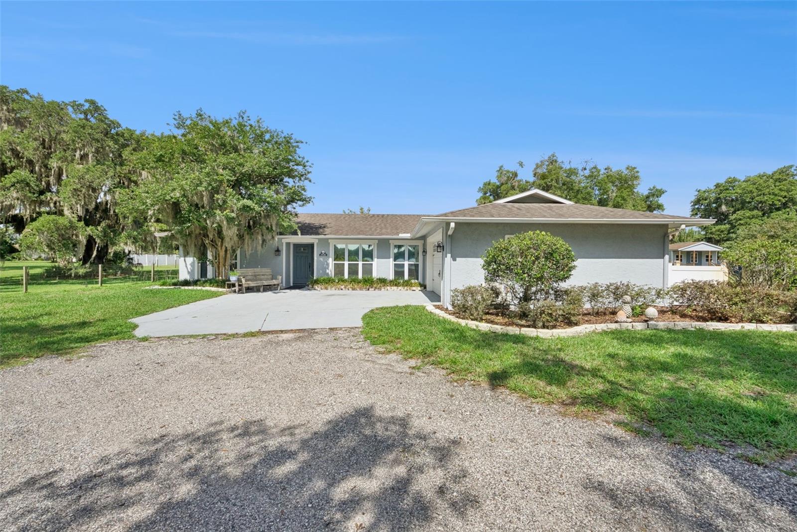 Don't miss this rare opportunity to own a beautifully updated home with private lake access to Lake Winnemissett. Situated on over an acre beneath majestic oak trees, this 3-bedroom, 2-bath property offers the perfect blend of privacy, comfort, and Florida outdoor living.

Inside, you'll find an open split-bedroom floor plan featuring custom crown molding, quartz countertops, black stainless steel appliances, luxury vinyl flooring, ceramic plank tile bathrooms, and expansive windows that fill the home with natural light while showcasing the peaceful surroundings.

Major updates include a roof installed in 2017, HVAC system replaced in 2021, brand-new septic tank and drain field in 2025, and new sprinkler system installed in 2025. The garage and detached shed/exterior office space have both been upgraded with new AC systems and new carpet, creating comfortable, flexible spaces perfect for a home office, gym, workshop, or additional storage.

Step through the French doors to your private outdoor retreat featuring a sparkling in-ground pool, fully fenced pool area, expansive covered paver patio, and plenty of space to relax or entertain. Pool pump replaced in 2023.

With two storage sheds, a two-car garage, lake access, and extensive recent upgrades, this property truly captures the best of Florida living.