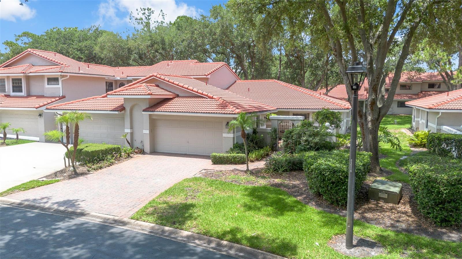 One or more photo(s) has been virtually staged. Welcome home to your highly sought after single story, end unit, Capri floor plan in the desirable gated Sandpointe Townhomes on the same street as the community amenities and swimming pool and in the heart of Dr. Phillips.  The most sought after floor plan in Sandpointe featuring neighbors only one one side, a light and bright open floor plan with plenty of natural light, walk-in closets in every room, new tile roof in 2021 plus a 2 car garage.  From the minute you pull up to the upgraded brick paver driveway you are greeted with lush tropical landscaping leading you to your privately gated courtyard; the ideal secure place for your little ones and pets to play or for a cookout or private organic herb garden. The inviting foyer leads you to an open light and bright floor plan that has been freshly painted featuring brand new carpet throughout and highlighted by crown molding.  The spacious kitchen features a quaint breakfast nook overlooking your private courtyard, Corian counter tops and a breakfast bar that opens up to the dining room making this the ideal location to serve your guests your favorite and most tantalizing culinary creations. The dining adjacent dining room features built in shelving and that are ideal to display your most prized art sculptures and opens up to the family room and onto the professionally enclosed and air conditioned Florida room with hurricane shutters for your peace of mind; the ideal flex space for a home office / gym / theatre, play room or a yoga or art studio.  The master retreat is privately tucked away in the back of the townhome and features an en-suite bath with a jetted garden tub that is sure to melt away your daily stresses, dual vanities, separate shower and bathroom stalls and a generous 5'x8' closet that is sure to satify the most disctiminating fashionista. Bedrooms 2 and 3 are privately located in a split plan configuration towards the front of the townhome and feature an adjacent guest bath with tub and shower.  Located around the corner from all of the community amenities and just down the street from Trader Joe's this perfect location offers the prefect balance of privacy while not compromosing convenience. The tile roof was replaced in 2020. Sandpointe offers a club house with a kitchen, a heated community pool, fitness studio, Bocce Ball court & tennis courts. Resort style living at its best in a gated community, with the HOA taking care of the exterior & roof maintenance, all the lawn maintenance plus a termite bond for your peace of mind. Enjoy an evening stroll to Trader Joe's & The Parkside community park which are around the corner. The Marketplace is minutes away featuring a wide array of shops & restaurants including the brand new Crunch Fitness, Christini's Ristorante Italiano, a Greenwise Publix, Starbucks & Home Goods & Home Sense for your last minute shopping needs. Preview your favorite book at Barnes & Noble, or visit one of the many restaurants on the famous Restaurant Row to curb any craving you may have. Dellagio is also around the corner offering specialty restaurants such as Dragonfly Sushi & Fleming's Steakhouse. All this in quite possibly one of the best locations in SW Orlando, close to major highways, shopping malls and all the area attractions.