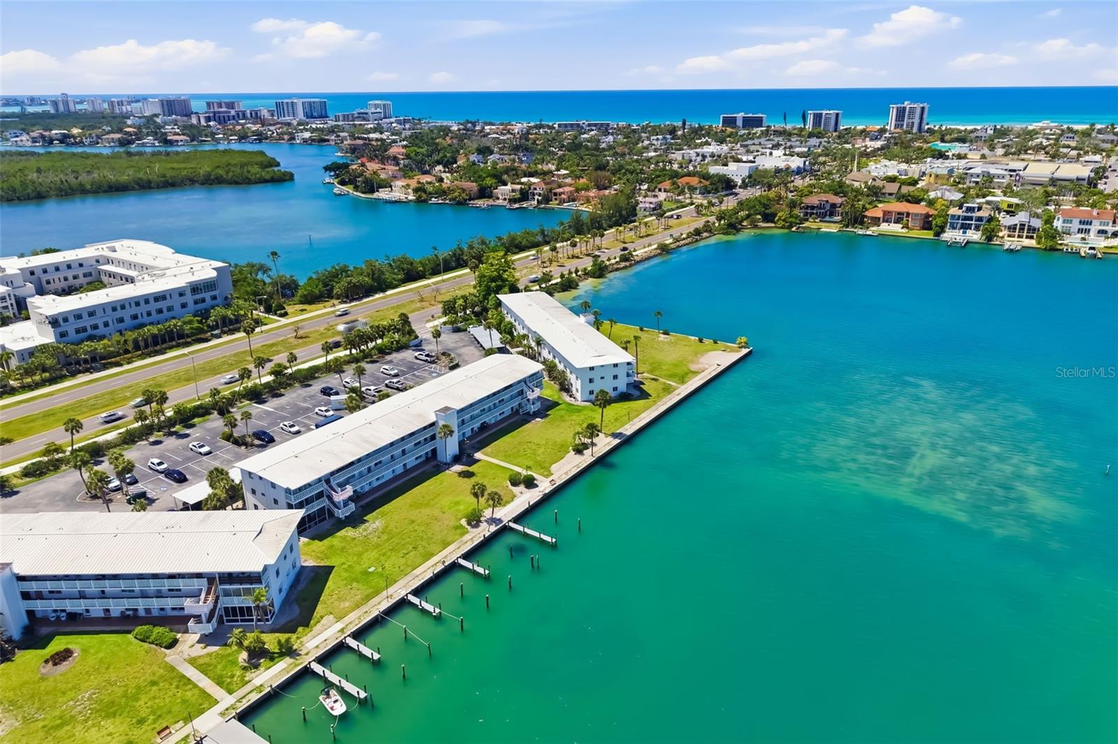 Few addresses in all of Sarasota deliver what 763 John Ringling Blvd offers every single day: direct, unobstructed views across Sarasota Bay with St. Armands Circle, Lido Key, and the sparkling Gulf of Mexico as your permanent backdrop. This is one of the most coveted waterfront corridors on the Gulf Coast, and this beautifully updated two-bedroom, one-bath residence puts you right in the middle of it.
Step outside and you are standing on the bay seawall with private community boat docks at your feet and open water stretching to the horizon. Dolphins cruise the shoreline in the morning. The Ringling Causeway glows gold at sunset. The bayfront community pool, shuffleboard courts, and waterfront walkway give residents every reason to stay close to home, while St. Armands Circle sits just minutes away across the bridge with its world-class European-style dining, boutique shopping, and lush tropical gardens.
Inside, the residence has been thoughtfully updated with hardwood floors, a refreshed kitchen with new appliances, and the rare convenience of an in-unit washer and dryer. The layout offers the right balance of comfort and ease, ideal for a full-time residence, seasonal retreat, or income-producing rental.
The address itself carries genuine historical significance. Unit 22 sits within the Harding Circle Historic District, a landmark community envisioned by circus magnate John Ringling and listed on the National Register of Historic Places since January 2001. This is not just a home. It is a piece of Sarasota's founding story.
Downtown Sarasota's waterfront arts district, marina, and restaurant scene are minutes away. Lido Beach is just over the causeway. For buyers relocating from the Northeast or Midwest, this property delivers the Gulf Coast lifestyle at an exceptional entry point: waterfront, walkable, and fully updated, with boat docking access and panoramic bay views that simply cannot be replicated at this price.