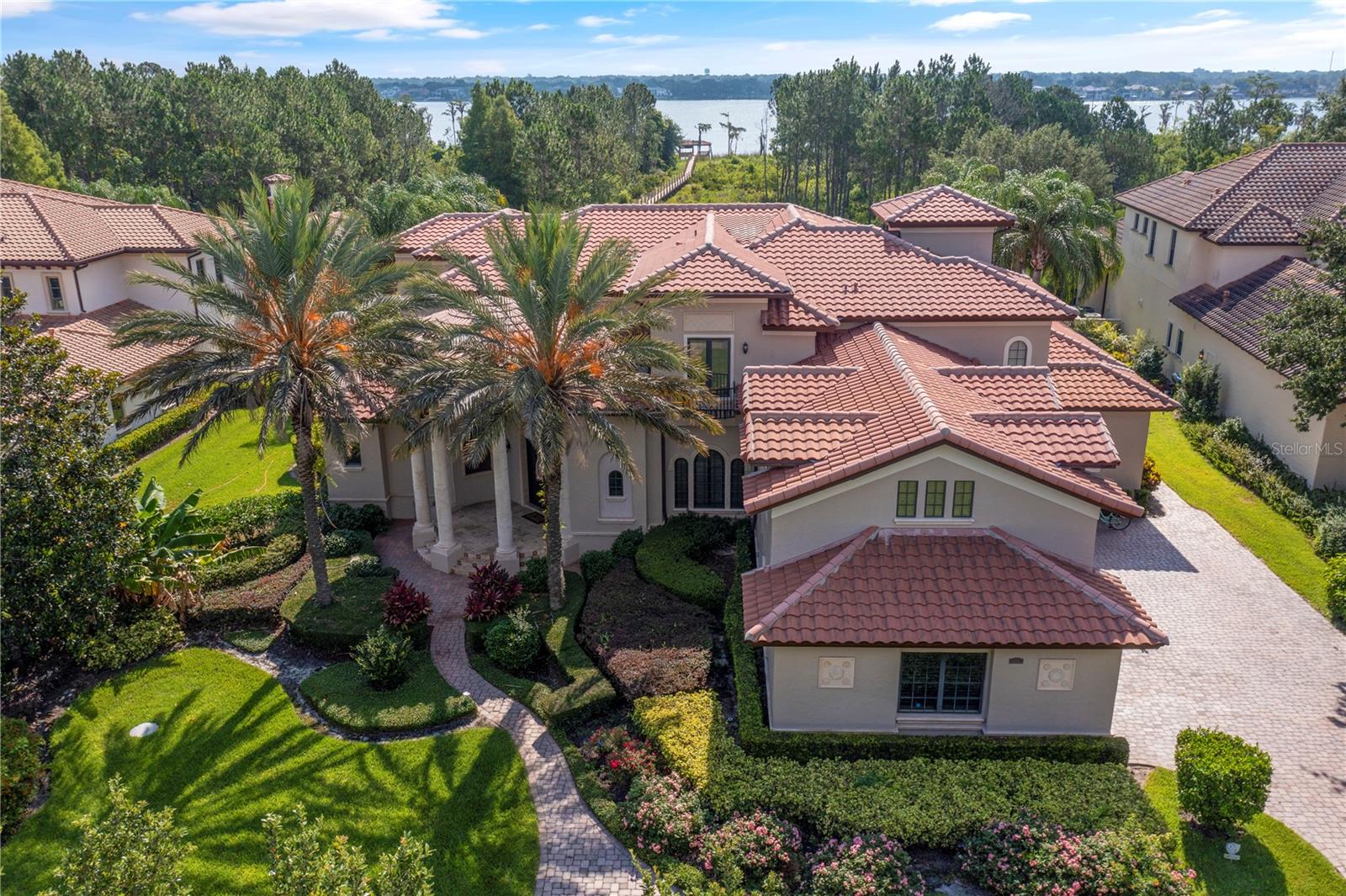 PRICED TO SELL AND MOVE IN READY!!   Remarkably well designed, well PRICED and located in Keene's Pointe, this 5BR/5 FULL Bath/ONE Half Bath, custom Lakefront Estate built by Master Custom Builder Goehring and Morgan awaits your arrival.   Thoughtfully designed with a family in mind, this home features a 4-CAR Garage PLUS golf cart bay and is sited on a 2.2 acre lot.   All your formal entertaining space is located on the main floor, along with the primary bedroom suite, a powder bath and another guest bedroom with full bath.   The second floor accommodates another whole world of its own with 3 bedrooms/3 bathrooms, a bonus room that could be another bedroom, the formal study with lake views, a huge gathering room with hospitality bar and a balcony for everyone upstairs to enjoy!   Amazing floor plan!  

The open pool area is surrounded by manicured landscaping, a tropical fruit orchard and a fully fenced enormous backyard.  Having pets is no problem as the oversized laundry room features a “pet”  shower!   The outdoor summer kitchen is set off in a screen enclosed back porch to protect you from the elements.    Covered lanai features a gas burning fireplace for those cool nights overlooking the vast  2.2 acre lot and the fading sunset on the horizon!  Let’s not forget the new ASKO decking along the beautiful boardwalk to Lake Tibet Butler where the pot of gold at the end is a large dock, covered boathouse and a sunning platform.   A hydraulic lift is a simple flick of the switch and a touchless remote boat cover makes boating an effortless task!   SELLER IS MOTIVATED TO SELL!!