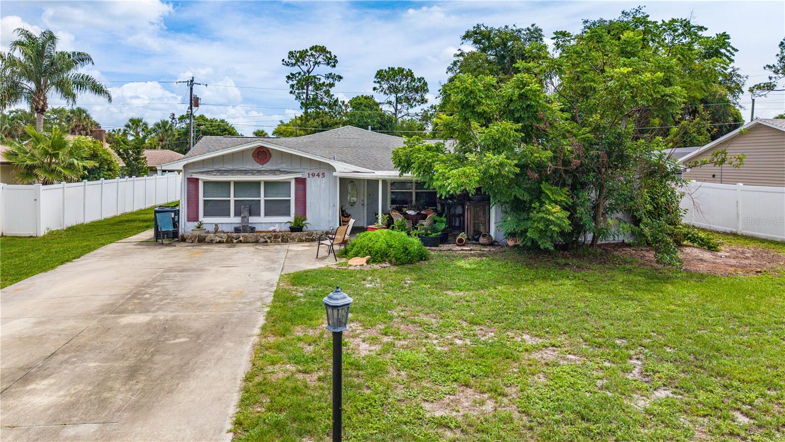Seller is motivated on this expansive 3-bedroom, 3-bath home in the heart of Florida Shores. This property delivers exceptional flexibility, including a highly desirable in-law suite with its own private bathroom and a large open studio-style layout—perfect for multigenerational living, guest accommodations, a hobby space, in home office space, or even an entertainment lounge. The main living area features an open, inviting layout with abundant natural light and plenty of room for both everyday living and entertaining. The kitchen offers generous counter space, ample cabinetry, and easy flow to the dining and living areas. All bedrooms are generously sized, and the home’s three full bathrooms provide comfort and convenience for a busy household. Outside, the property offers room for outdoor living, gardening, and a large storage shed. A large driveway and additional parking options make this home practical for households with multiple vehicles, RV, boat, or visitors. Seller is offering a new roof with a full price offer, giving buyers peace of mind for years to come. The seller is also offering a new appliance package credit, allowing the next owner to select the style and finishes they prefer. NO HOA and no flood history located in low-risk Flood Zone X. Situated minutes from New Smyrna Beach, shopping, parks, boat launch, and schools; this home combines space, versatility, and a prime Edgewater location. Motivated seller — offers encouraged, make this spacious Florida Shores property your own.