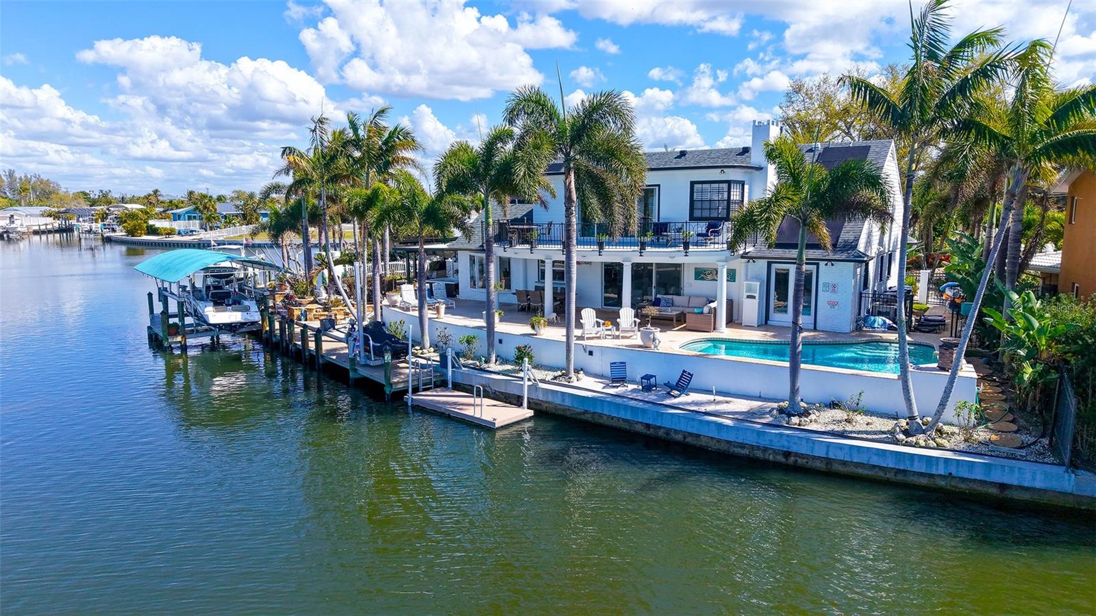 The Jewel of Flamingo Cay. Experience over 3,000 square feet of refined waterfront living, perfectly positioned to capture breathtaking sunset views. This exceptional residence offers 4 bedrooms, 2 bathrooms, a private den/office, and a versatile bonus room, providing flexible space for both everyday living and entertaining.

Designed for the boating enthusiast, this saltwater canal property offers direct access to open water with no fixed bridges, a 150-foot private seawall, and a 12,000-lb boat lift—allowing you to be on plane just moments after leaving your dock.

The home has been tastefully updated with high-end finishes, including Italian Lube cabinetry, Miele appliances, Hunter Douglas window treatments, and premium countertops and flooring, creating a sophisticated yet comfortable coastal atmosphere.

Multiple outdoor living spaces, including open and covered decks and a private balcony off the primary suite, overlook the heated pool and tranquil bayou, offering the perfect setting for relaxation or entertaining. The outdoor experience is enhanced with a fireplace, travertine patios, and lush tropical landscaping, all fully fenced for privacy.

Nature lovers will appreciate the ability to kayak or paddleboard directly to the 600+ acre Robinson Preserve in minutes, while dolphins and manatees frequently visit the waters just beyond your backyard.

Ideally located, Flamingo Cay offers quick access by boat or car to waterfront dining, marinas, and the world-renowned beaches of Anna Maria Island.

Additional highlights include a 2021 roof and both AC systems, along with the rare benefit of over 3,000 square feet within one of the area’s most sought-after canal communities.

Flamingo Cay features a voluntary HOA.

This is a rare opportunity to own a spacious waterfront retreat in one of West Bradenton’s most desirable boating communities.

Come experience the lifestyle that makes Flamingo Cay such a special place to call home.