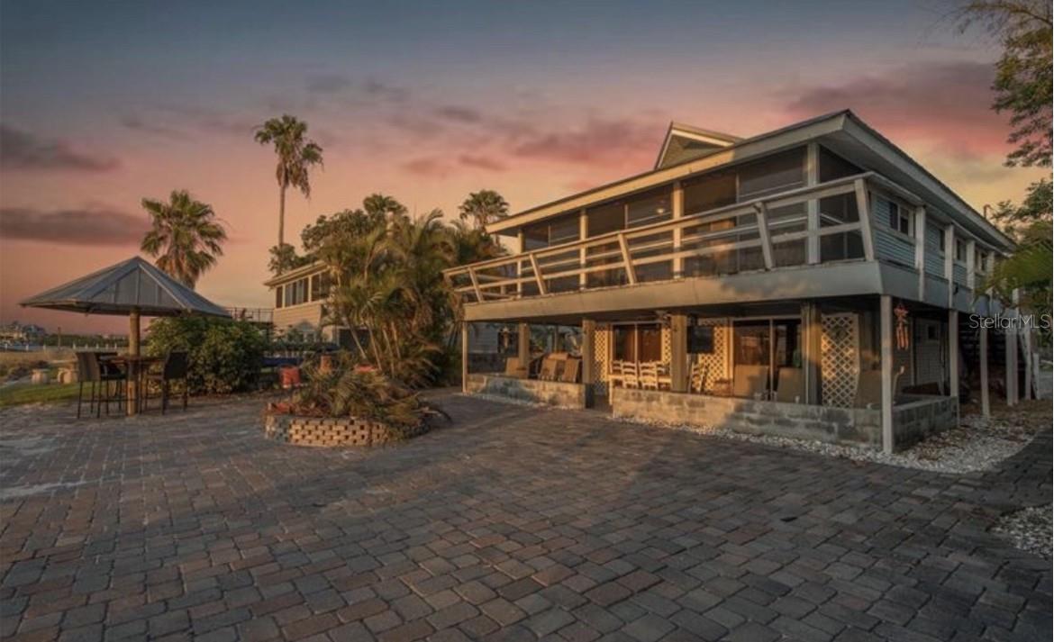 Investor Special! An extraordinary opportunity to own a rare waterfront property directly on Tampa Bay with unobstructed panoramic views of St. Petersburg and some of the most breathtaking sunsets Florida has to offer. The true value is in the land and the incredible location, making this the perfect opportunity to renovate the existing home or build the custom waterfront estate of your dreams.

The home sustained hurricane damage, but the upper level remains livable while the lower level offers the opportunity for renovation and restoration. The existing dock is also in place and has the potential to be repaired, adding even more value to this exceptional property.

The photos provided showcase what this home looked like prior to the hurricane and offer a glimpse into the property's incredible potential. Whether you're an investor, builder, or visionary buyer looking to create something truly special, opportunities like this are few and far between.

Renovate. Reimagine. Rebuild. But no matter what you choose, it's the view that is truly priceless.

Sold as-is. Cash or renovation financing preferred. Don't miss your chance to own a piece of Tampa Bay waterfront paradise.