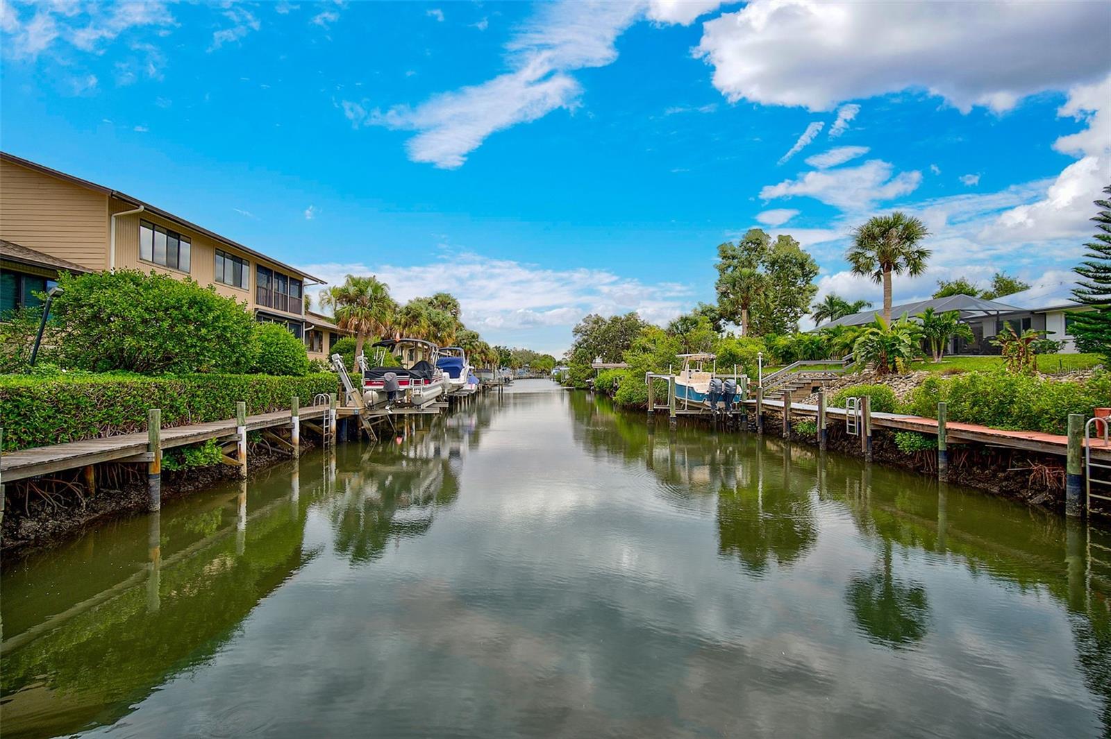 Experience the best of Florida waterfront living in this beautifully updated turnkey furnished 3-bedroom, 2-bath condo situated on a peaceful canal with direct boating access to Sarasota Bay. This light-filled residence offers an open-concept layout, vaulted ceilings and everything you need to move right in and start enjoying the lifestyle.

Step outside to your private boat slip and lift, making it effortless to spend the day cruising the bay, exploring nearby waterfront restaurants, or heading out to the Gulf. Inside, the spacious living and dining areas flow seamlessly to a enclosed lanai where you can relax and take in tranquil water views.

The well-appointed kitchen features ample cabinetry and counter space, while the primary suite offers water views, generous closet space, and an en-suite bath. The split bedroom floor plan provides plenty of room for guests, family, or a home office.

Whether you’re looking for a full-time residence, seasonal retreat, or investment opportunity, this exceptional canal-front condo combines comfort, convenience, and easy access to Sarasota Bay in one perfect package. This condo is located in a quiet gated community of only 36 units close to all conveniences. This second and top floor spacious unit has the largest floor plan and feels more like a single family home, vaulted ceilings and an open floor plan with split bedrooms. It's a short walk over the bridge to Siesta Key beaches. Quick access to the intercoastal and bay by boat, no bridges to navigate, makes it easy to go to the many waterfront restaurants. The huge primary ensuite overlooks the canal and has a walk in shower/closet, dual sinks, king bed, separate tub and WC. The detached 2 car garage has a separate AC unit. Seller had the 6000 lb lift refurbished in 2023. New roof in 2023. The air ducts and dryer vent were cleaned in January 2024. The condo is only steps from the heated pool. It's a 10 minute drive to downtown Sarasota. Walk or bike to the world famous Siesta Key Beach or take a trolley. You are within a mile of every convenience you can think of. This community is a hidden gem. All offers must provide proof of funds or pre-approval with offer.
