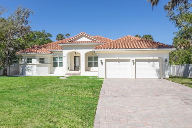 Experience refined coastal living in this exceptional residence!
Designed with elegance and comfort in mind, this stunning 4-bedroom, 3-full bath home offers an elevated lifestyle just minutes from the sun and surf of Flagler Beach.  Step inside to discover a bright and open floor plan featuring a formal living room, dining room plus a spacious family room, ideal for everyday living and entertaining.  A private study provides the perfect retreat for remote work, reading or creative pursuits.  At the center of the home, the chef's kitchen is a true showpiece.  Thoughtfully designed with premium finishes, an expansive center island, custom cabinetry, quartz countertops and premium appliances, it seamlessly blends beauty and function.                                                                                                                                                                                                                                                                                                                                                                                                                   The luxurious primary suite is generously sized and filled with natural light, a tray ceiling and en-suite bath.  The primary bath is spa-inspired, featuring a spacious walk-in shower, soaking tube and his and her vanities.  Three additional bedrooms with two well-appointed bathrooms present comfort and privacy for family and guests alike.  Every detail throughout the home reflects quality craftsmanship and timeless design. This thoughtfully upgraded home features 5" crown moldings, new luxury laminate vinyl flooring in the main living areas, lots of recessed lighting, ceiling fans, a paver driveway, walkway and a large travertine floored lanai overlooking a sizable private yard with plenty of room for a pool.  Note this home was built with a solid 4-foot stem wall foundation and the attic insulation (R-35) is Cereta Spray 5" foam spray under the entire roof, over the heated and cooled living areas, sealed and conditioned.  The propane gas tank, used for cooking, is leased not owned by the Seller.                                                                                                                                                                                                                                                                   This move-in ready home combines privacy, elegance and convenience all within a short drive to Flagler Beach, shopping and dining.                                                                                                                                                                                                                                               Don't miss this exceptional property, schedule your private showing today!