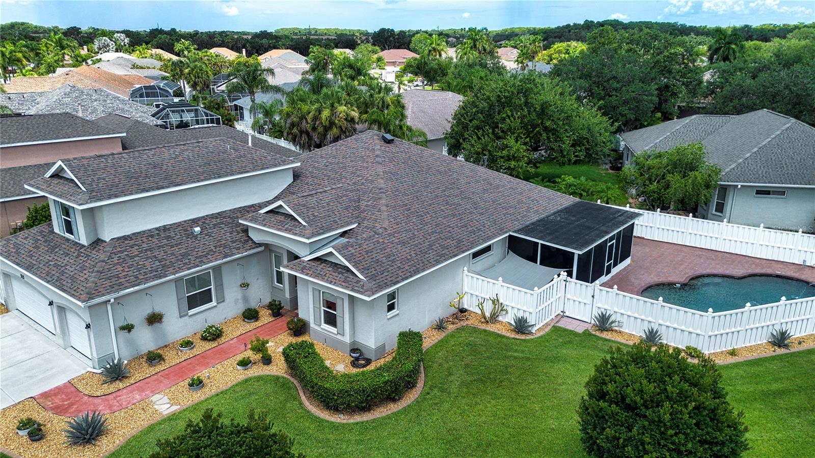 Welcome to 515 Planters Manor Way, where luxury, space, and an unbeatable location come together in one of Bradenton's most desirable communities. Situated on a beautifully landscaped oversized corner lot in the sought-after Greenfield Plantation public golf course community, this exceptional 3,200+ square foot home offers a rare combination of features that are difficult to find—a spacious 3-car garage, fully updated interior, private heated saltwater pool and spa, NO CDD fees, and low HOA fees.

From the moment you arrive, you'll appreciate the outstanding curb appeal, elegant double frosted-glass front doors, and quality upgrades throughout, including new impact-resistant windows on the front elevation installed in 2024. Inside, the open-concept floor plan showcases beautiful bamboo flooring, crown molding, oversized baseboards, a tray ceiling, recessed lighting, designer fixtures, and plantation shutters, creating an elegant yet comfortable living environment.

The gourmet kitchen is designed to impress with granite countertops, maple soft-close cabinetry with pull-out drawers, stainless steel appliances, a natural gas cooktop, double ovens, decorative tile backsplash, an oversized sink, abundant storage, and a large center island—perfect for entertaining or everyday living.
The spacious primary suite serves as a private retreat featuring matching laminate flooring and a spa-inspired bath highlighted by a luxurious Pulse Shower Spa system. Upstairs, a versatile bonus room with a full bath and two closets offers endless possibilities as a guest suite, game room, media room, hobby space, or even a fifth bedroom.

Step outside and discover your own backyard oasis. The fully fenced yard surrounds a stunning 15,000-gallon heated saltwater pool and spa featuring a pebble stone finish, natural stone spa accents, a brick paver deck in a herringbone pattern, a screened lanai with low-maintenance polyaspartic flooring, ceiling fans, and an expansive patio complete with a motorized retractable awning—creating the perfect space to relax or entertain year-round. The pool equipment was replaced in 2023, providing added peace of mind and efficiency.
A rare feature in this community, the oversized 3-car garage offers exceptional flexibility with its durable polyaspartic floor coating, ceiling-mounted storage racks, and extra depth that easily fits three vehicles while leaving plenty of room for a workshop, storage cabinets, or recreational gear.

Additional premium features include:
• New impact-resistant front & side elevation (forward of backyard fence) windows (2024)
• Insulated rear windows with aluminum hurricane shutters
• New water heater (2023)
• Natural gas service
• Solar-powered attic ventilation fan
• Owens Corning Tru-Protection 50-year roof material warranty
• Move-in ready condition with extensive updates throughout

The location is just as impressive. Residents enjoy the benefits of a public golf course community while being within walking distance to highly rated A-rated schools, shopping, dining, parks, and everyday conveniences. With NO CDD fees, low HOA dues, exceptional upgrades, and a floor plan rarely available in this neighborhood, this home represents an outstanding opportunity for buyers seeking luxury, functionality, and long-term value.

This is more than just a home—it's a lifestyle. Schedule your private showing today and experience everything 515 Planters Manor Way has to offer.